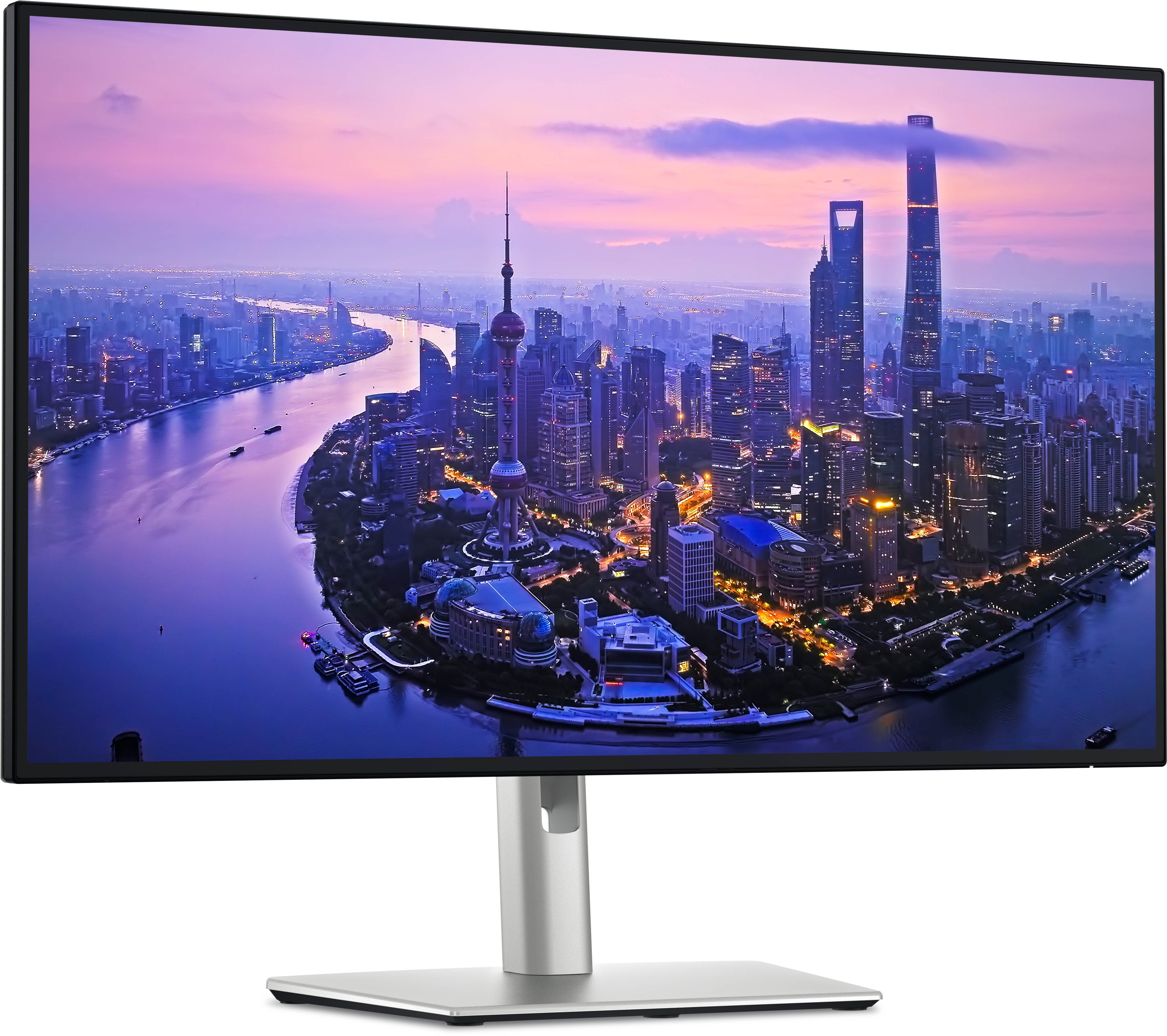 Ein Computermonitor zeigt eine Stadtlandschaft in der Abenddämmerung, Fluss im Vordergrund. Hohe Gebäude und ein Turm sind sichtbar.