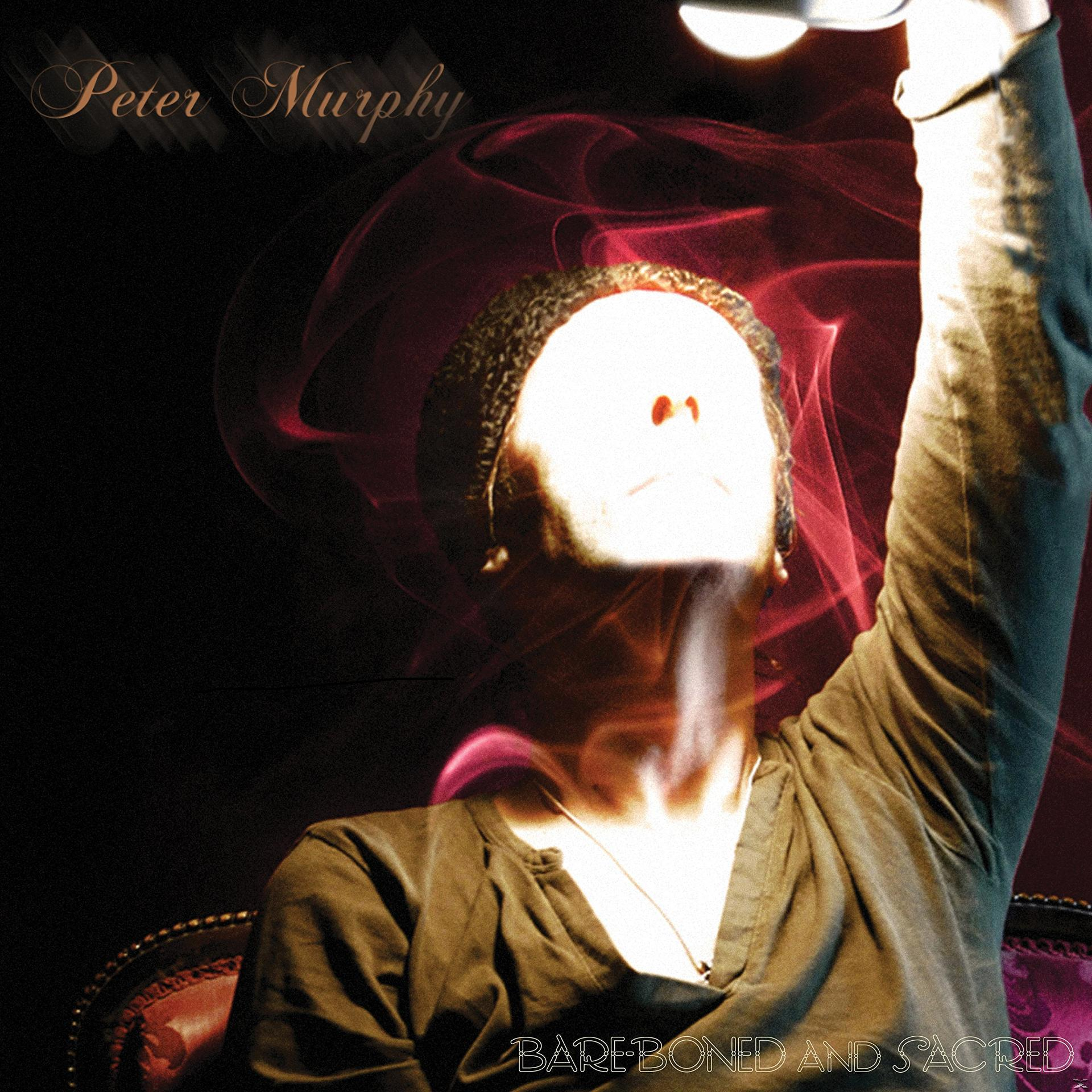 Peter Murphy album borítója. Férfi felemelt karral, felette fény. Piros füst örvénylik. A szöveg: 'Bare Boned and Sacred'.