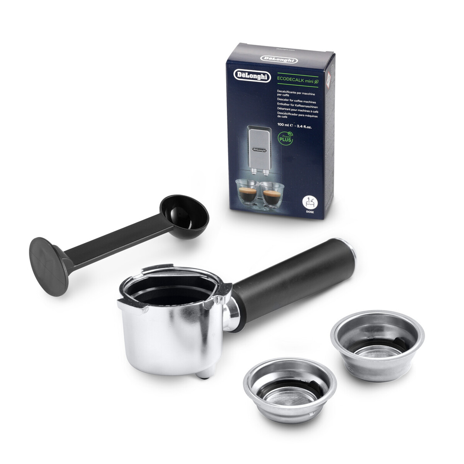 Coffee machine parts: portafilter, filter baskets, scoop, and descaler box, all on a white surface.