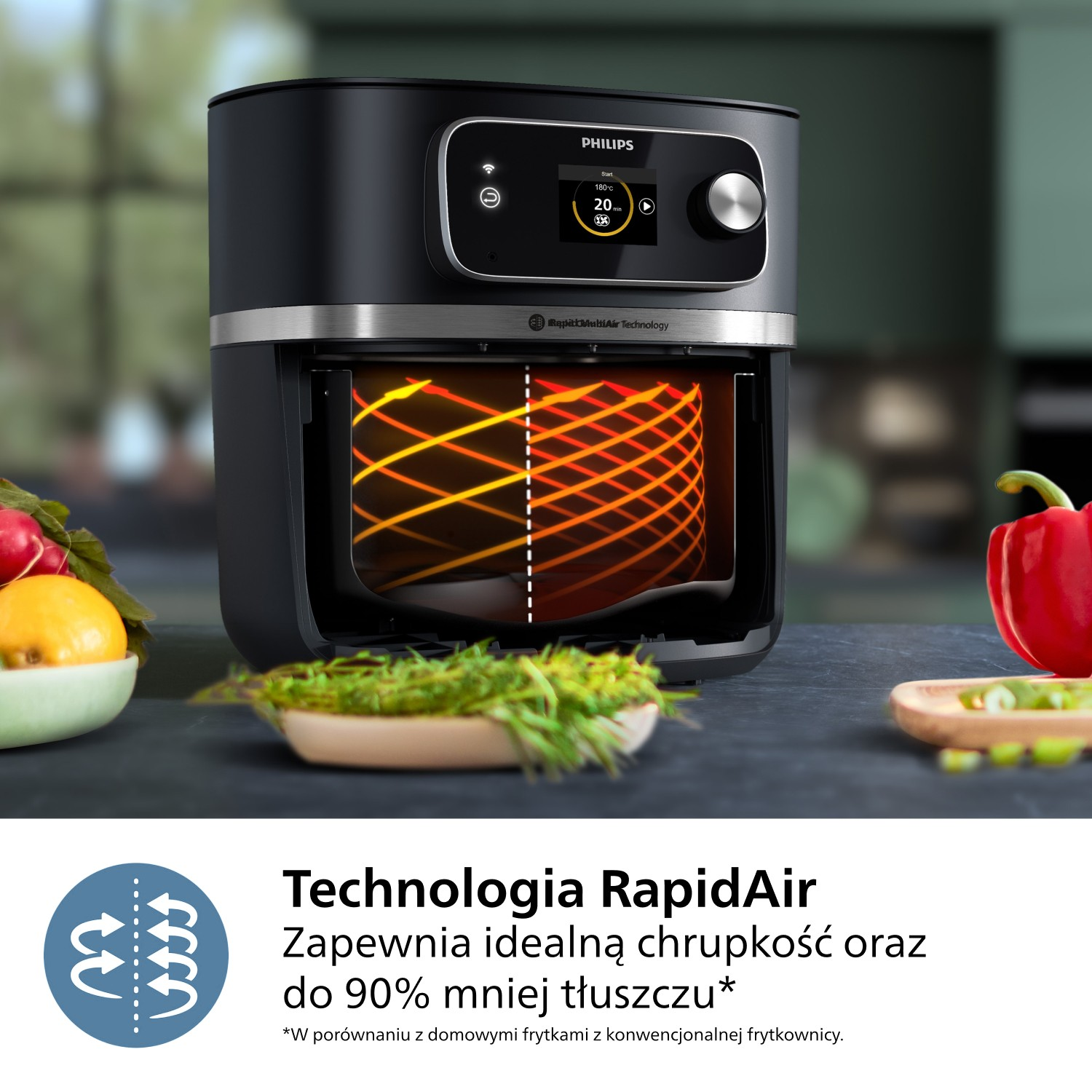 Czarna frytkownica Philips z jedzeniem w środku. Widoczne warzywa w miskach i tekst o technologii RapidAir.