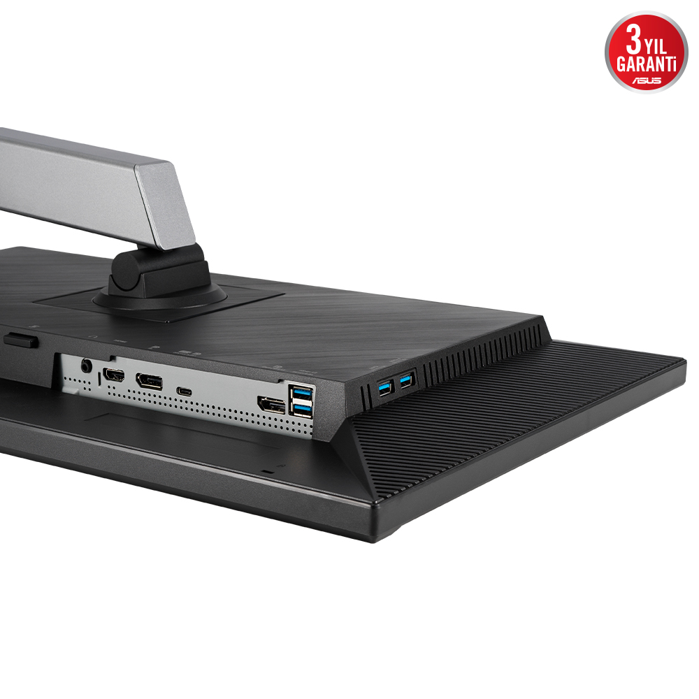 Gümüş bir standa sahip siyah bir monitör. Çoklu bağlantı noktaları ve ASUS logosu var. Bir garanti mührü sağ üst köşede.