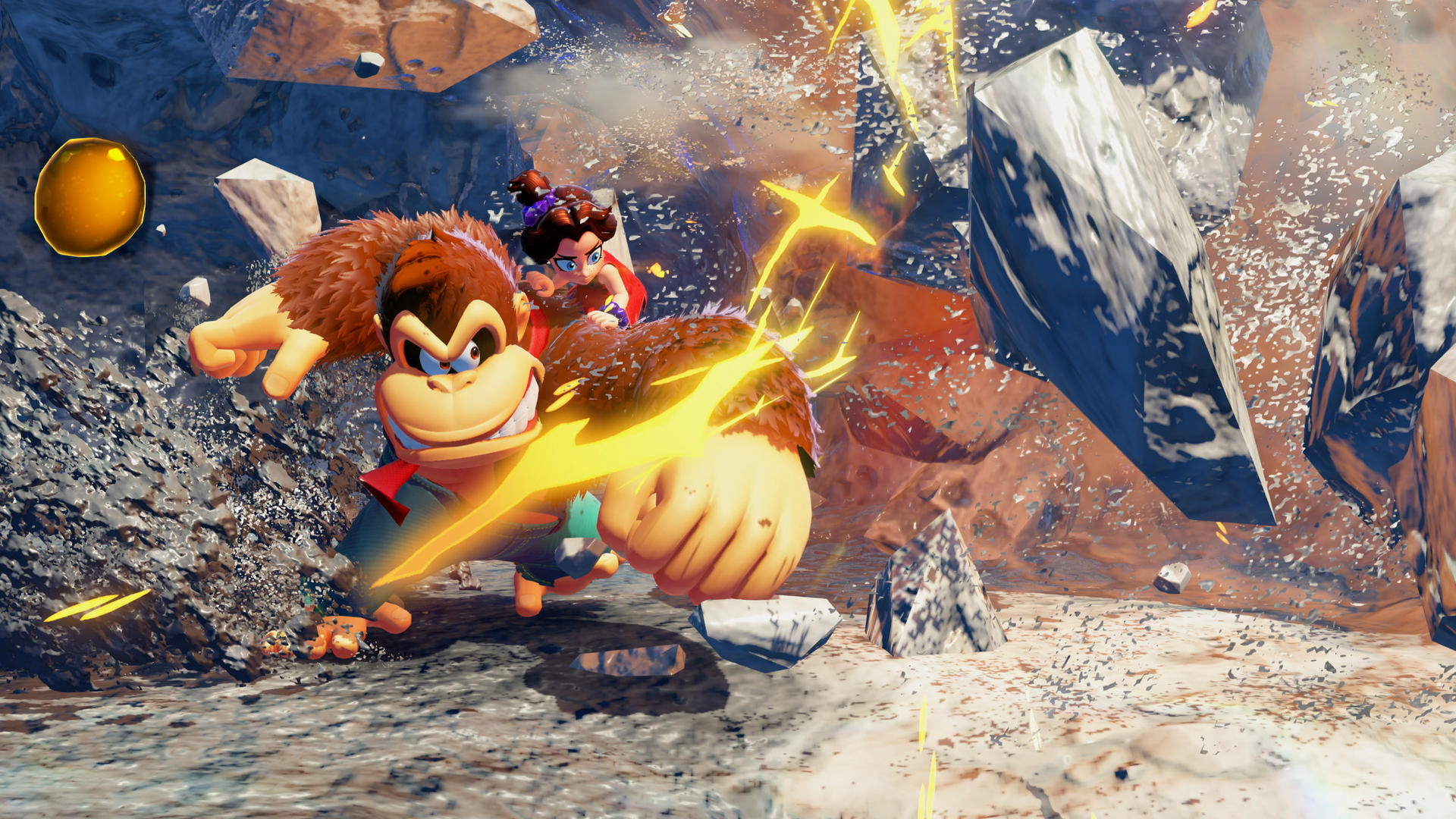 Donkey Kong boxt, mit Diddy Kong auf dem Rücken. Felsen und Explosionen im Hintergrund. Links ist eine goldene Kugel.