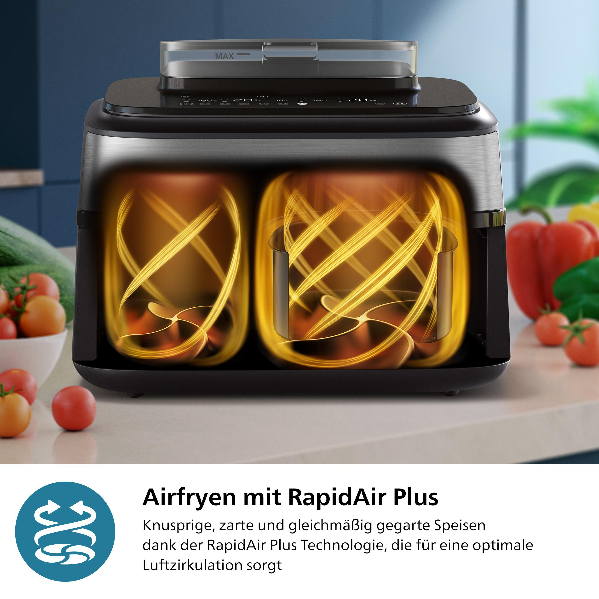 Ein Airfryer mit zwei Kammern. Goldene Luftwirbel im Inneren. Tomaten und Paprika liegen auf der Theke.