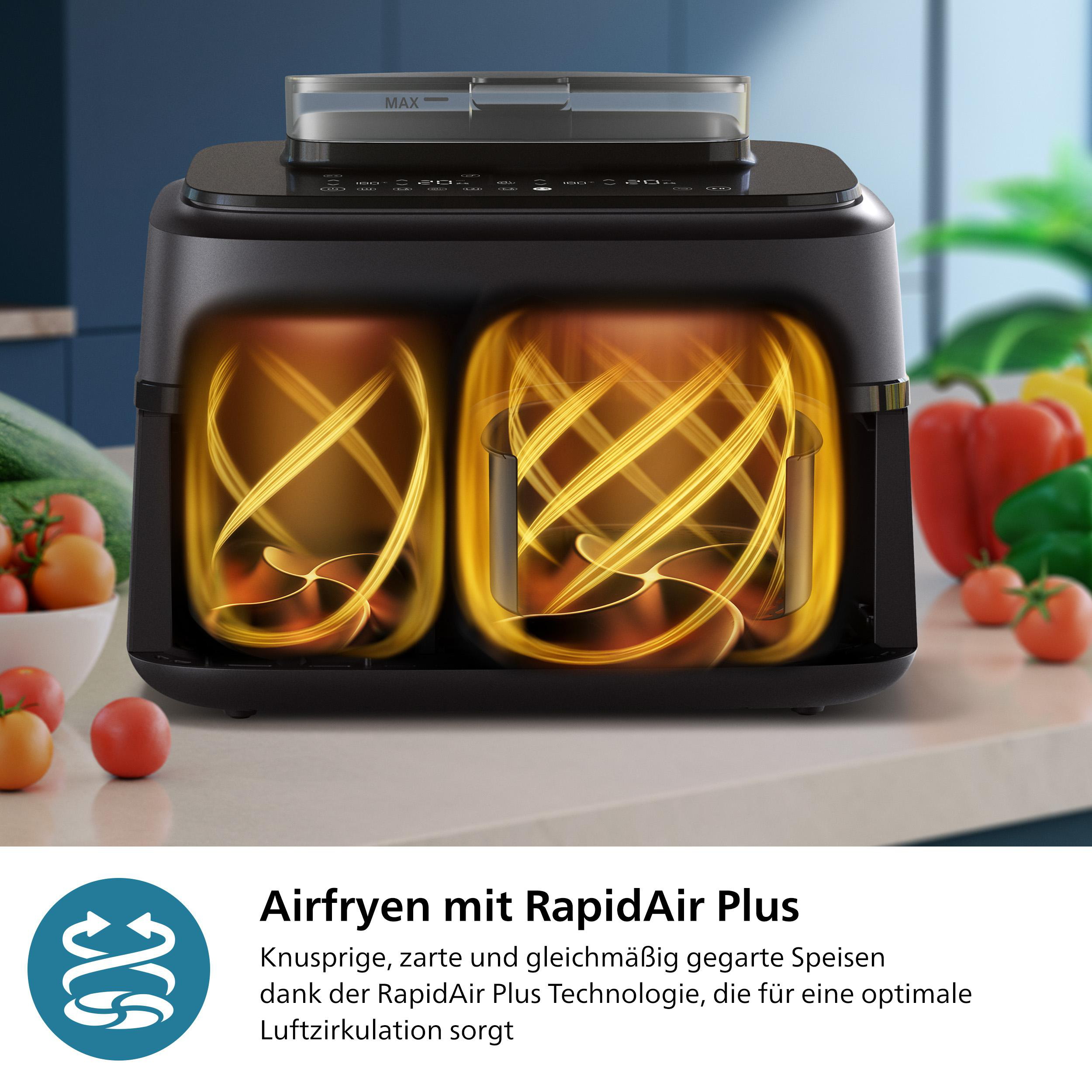Schwarze Heißluftfritteuse mit zwei Kochkammern. Goldene Lichtwirbel im Inneren, mit Tomaten und Gemüse im Hintergrund.