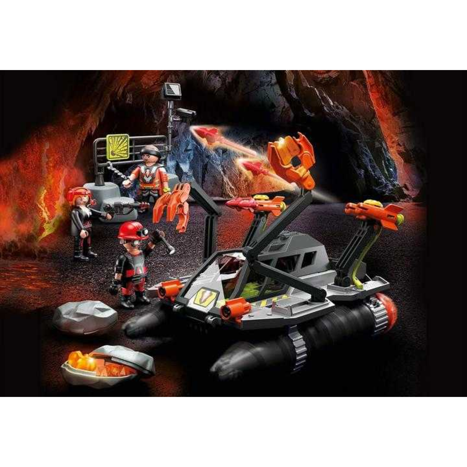 A Playmobil set depicts a volcanic scene with figures, a vehicle, and accessories. The background shows a cave with lava and rock formations.