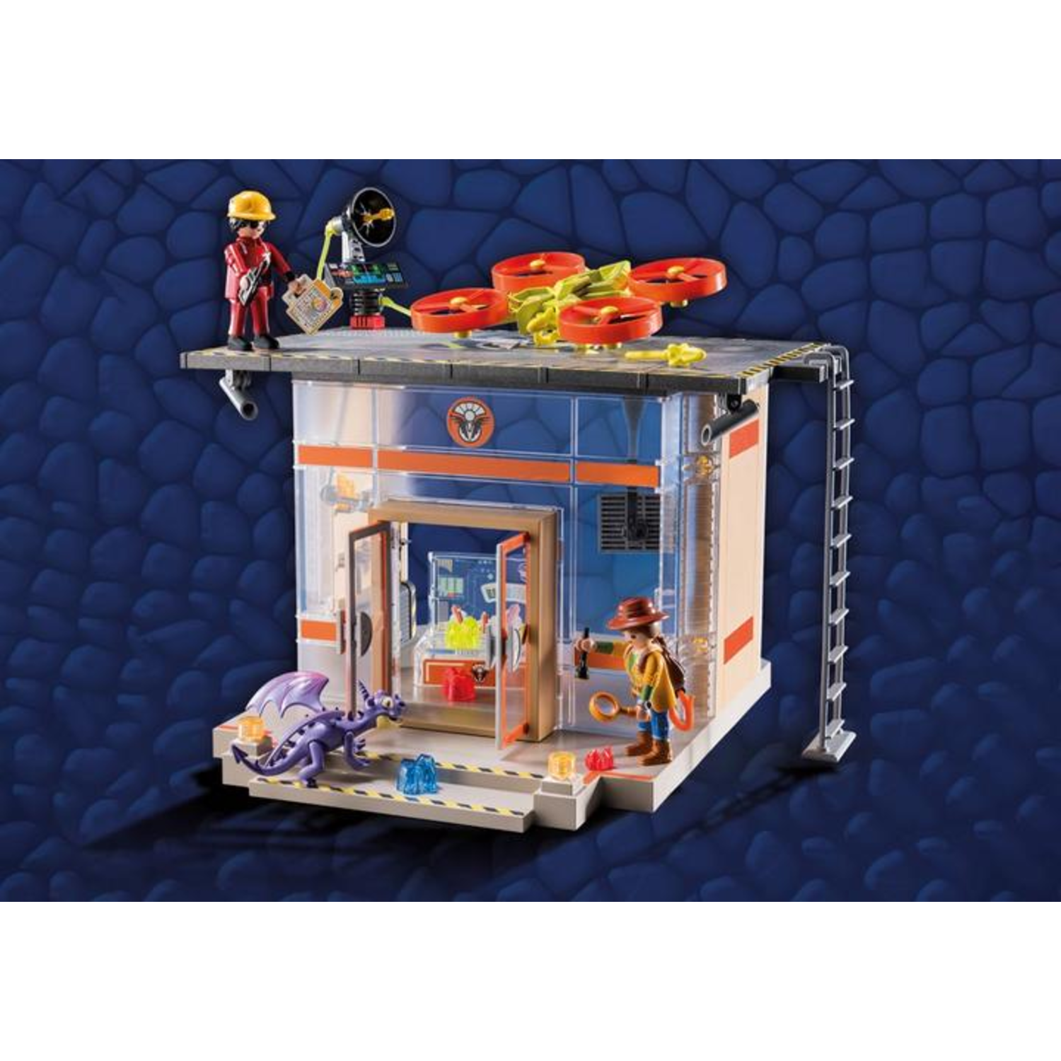 A toy scene depicts a building with figures, a dragon, and a drone. A figure on the roof. Another figure stands near the open door.