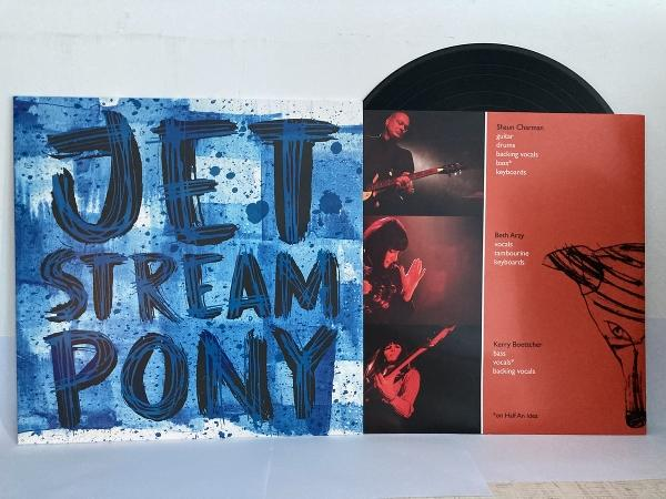 Albumcover: "JET STREAM PONY" in Blau auf blau gesprenkeltem Hintergrund. Eine Schallplatte ist sichtbar. Album zeigt Bandfotos.