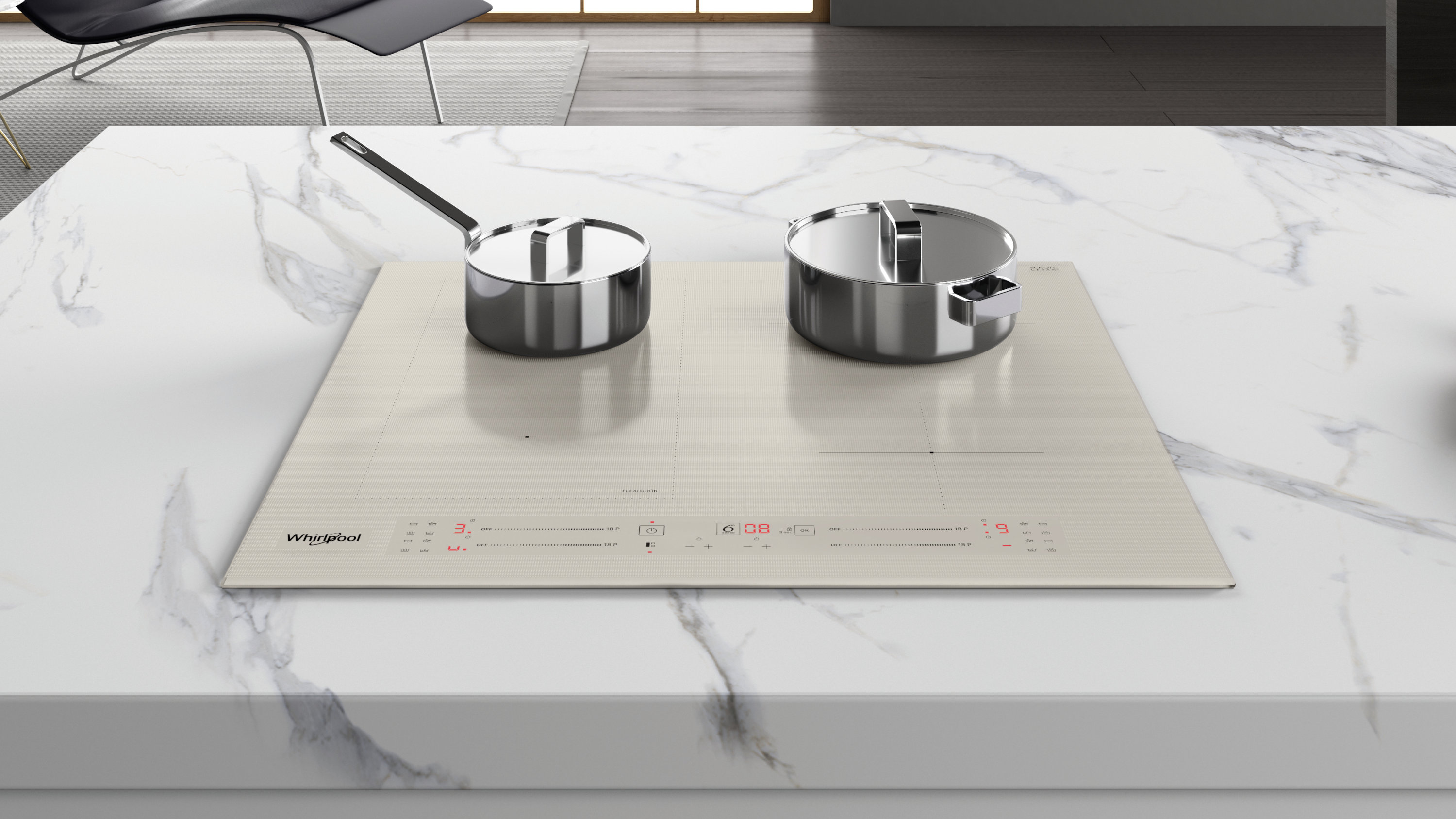 Garnki ze stali nierdzewnej na beżowej płycie indukcyjnej na marmurowym blacie. Czarny fotel w tle.