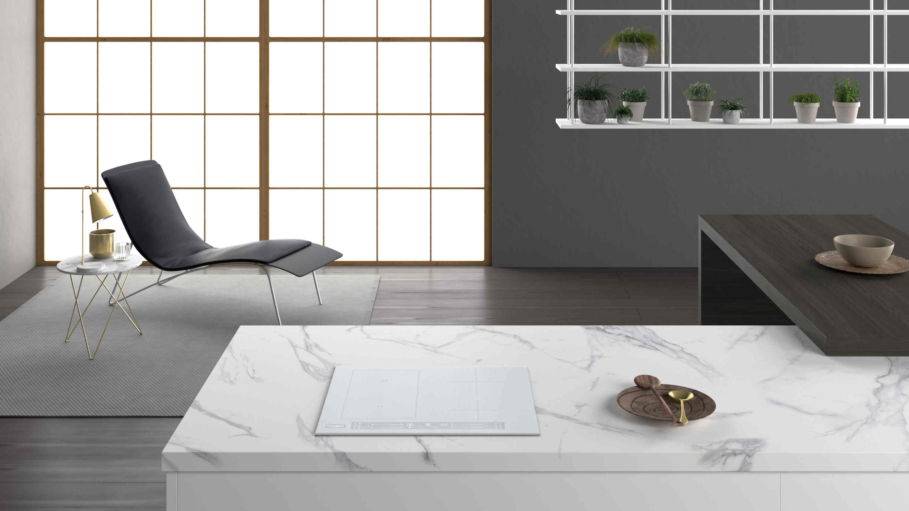 Nowoczesna kuchnia z białym marmurowym blatem, płytą indukcyjną, leżanką, dużym oknem. Rośliny na półkach.