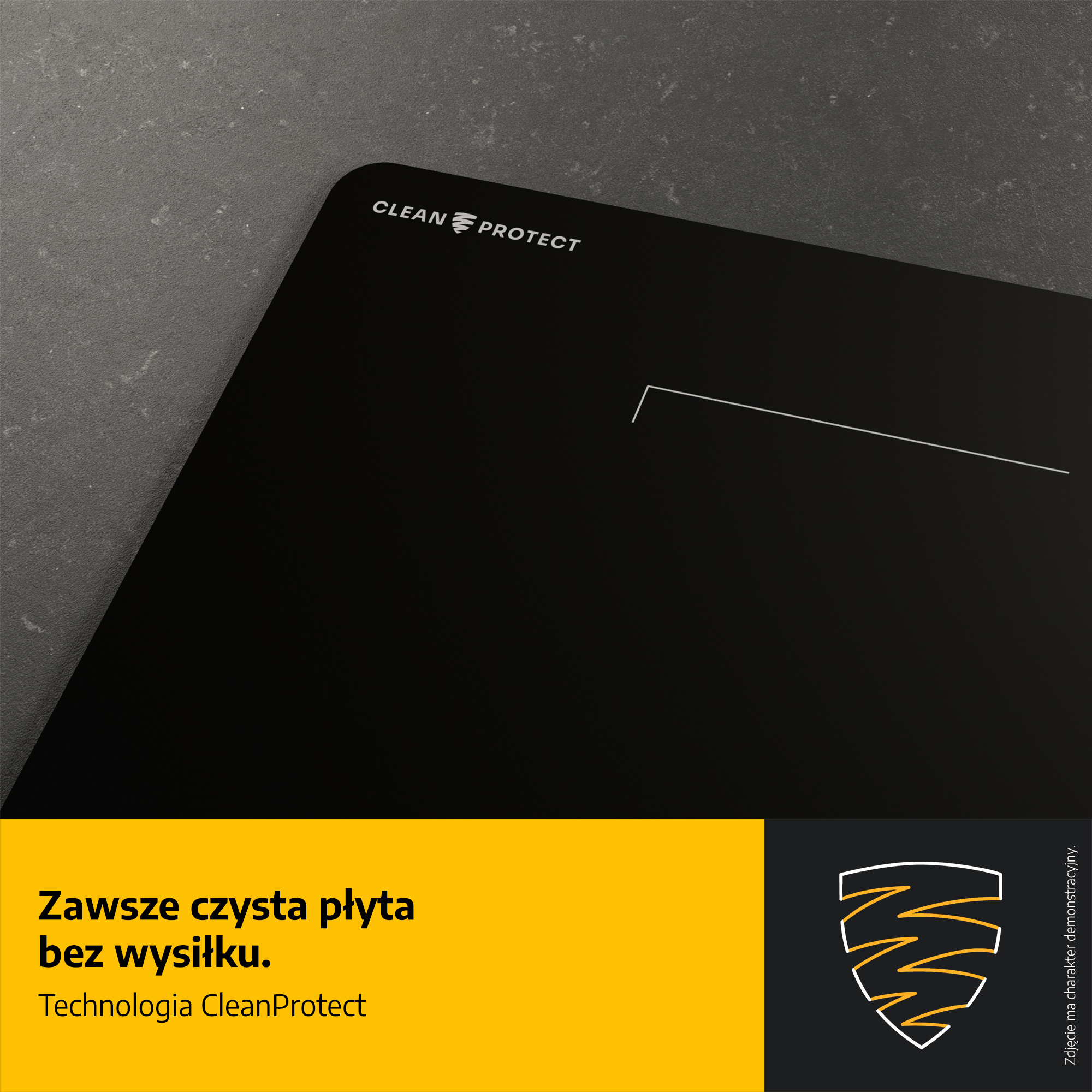 Czarna płyta indukcyjna z białą linią, tekstem CLEAN PROTECT oraz pomarańczowo-czarnym blokiem informacyjnym.