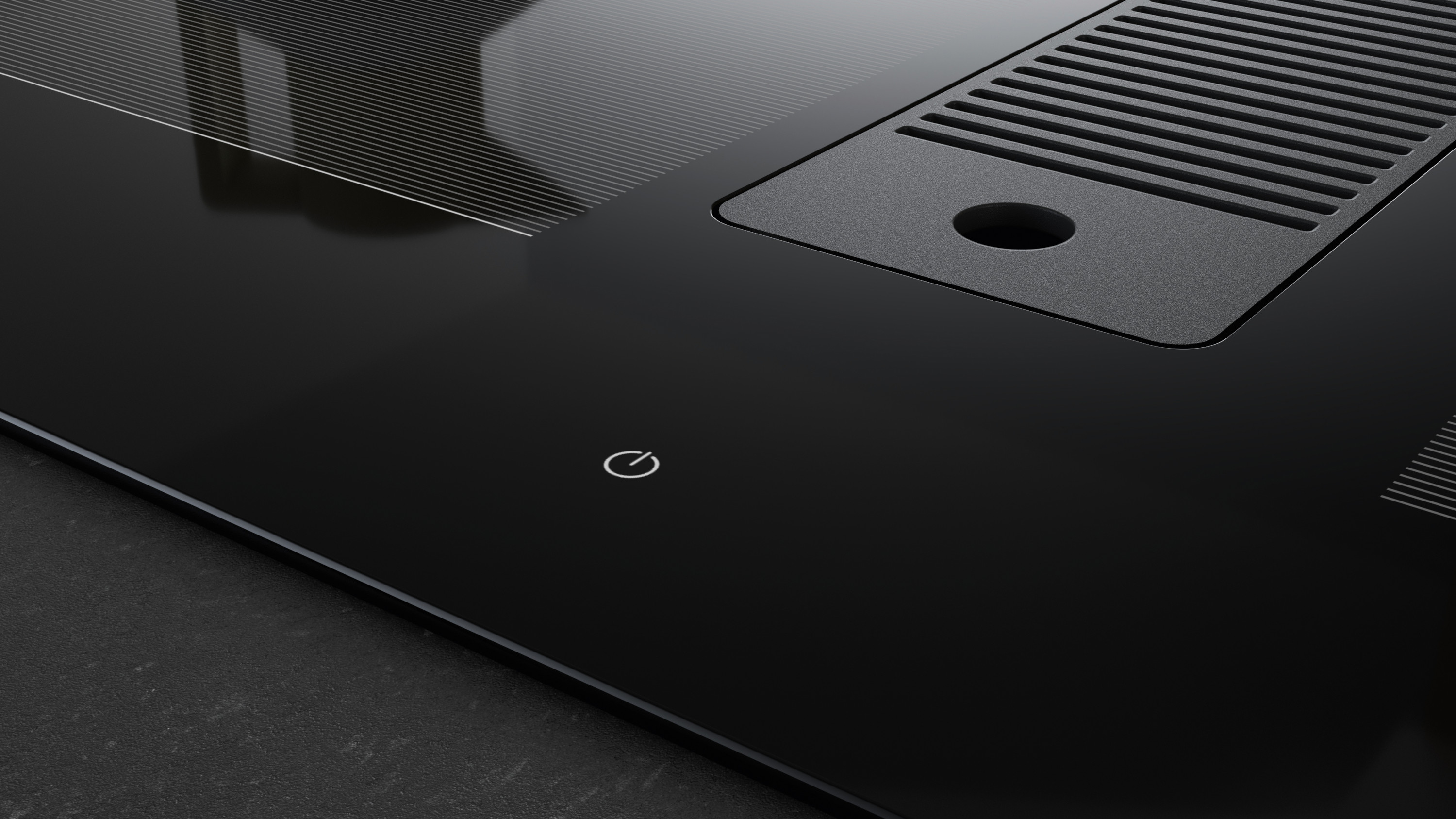 Zbliżenie czarnej płyty kuchennej z przyciskiem zasilania, wentylacją i teksturowaną powierzchnią. Płyta jest czysta i nowoczesna.