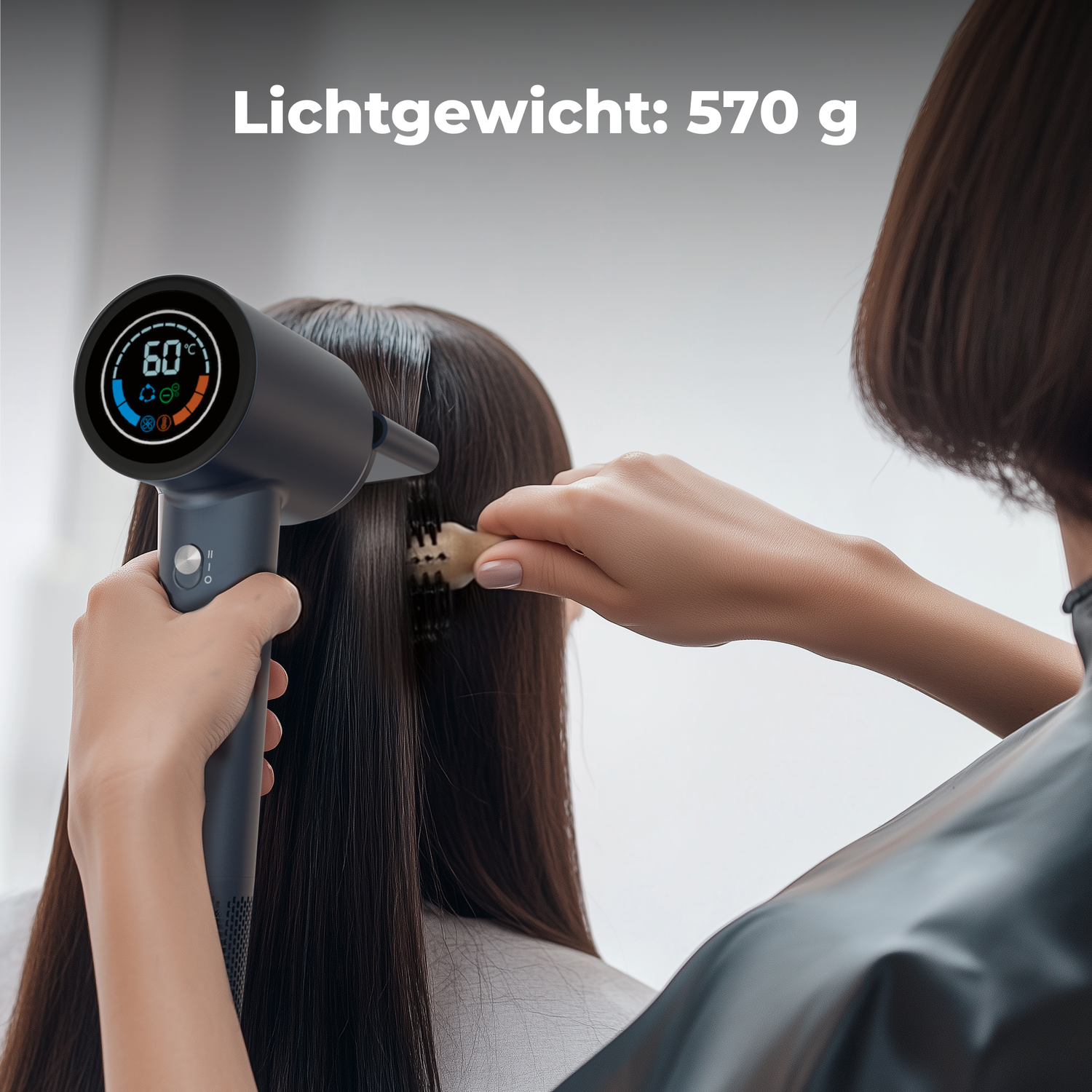 A person is using a hairdryer on someone's hair. The hairdryer shows 60 degrees. The text 'Lichtgewicht: 570 g' is on the top.