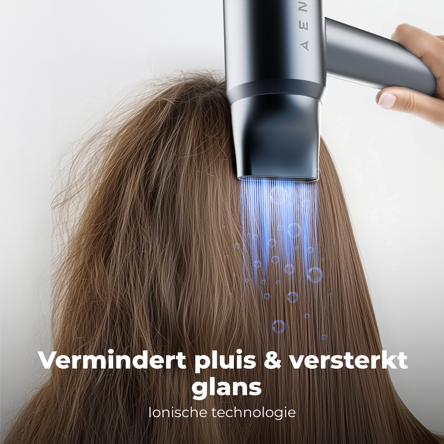 A hair dryer is used on brown hair, emitting blue light. Text at the bottom reads 'reduces frizz & enhances shine'.