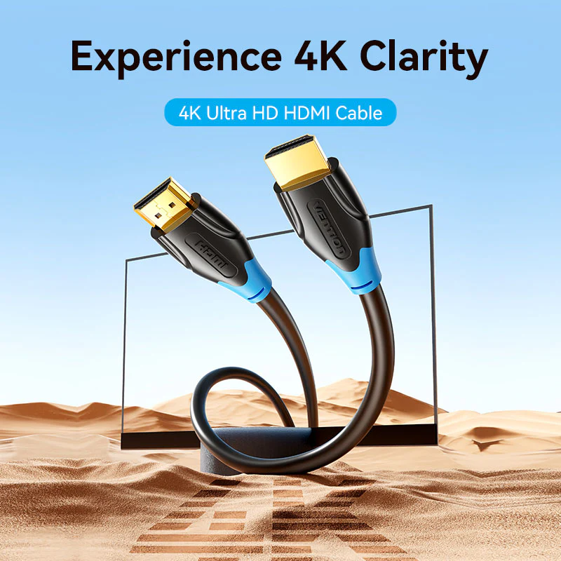 Két HDMI-kábel arany csatlakozókkal, a TV-képernyő képével szemben, sivatagi háttérrel és kék éggel.