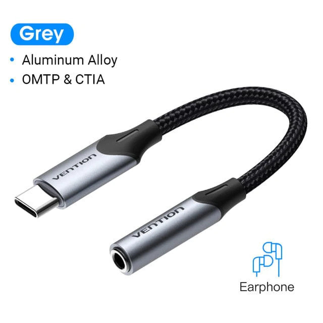 Egy szürke Vention USB-C - 3,5 mm-es audio adapter. A kábel fekete. A terméken a 'Vention', 'Aluminum Alloy' és 'Earphone' feliratok láthatók.