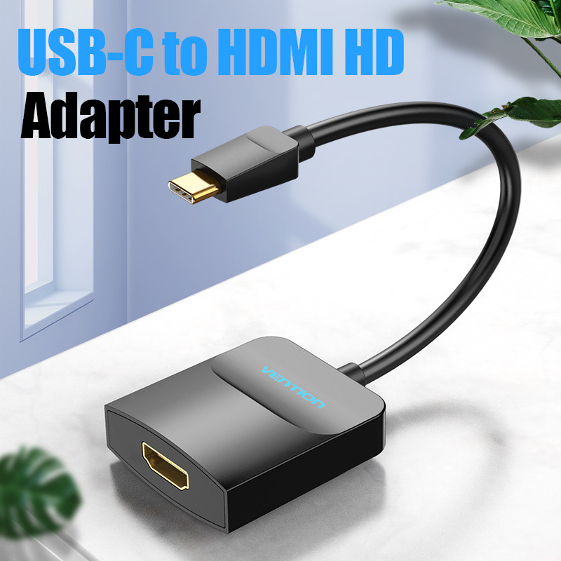 Egy fekete USB-C-HDMI adapter. Felül a szöveg: 'USB-C to HDMI HD Adapter'. Az adapter fehér felületen van.