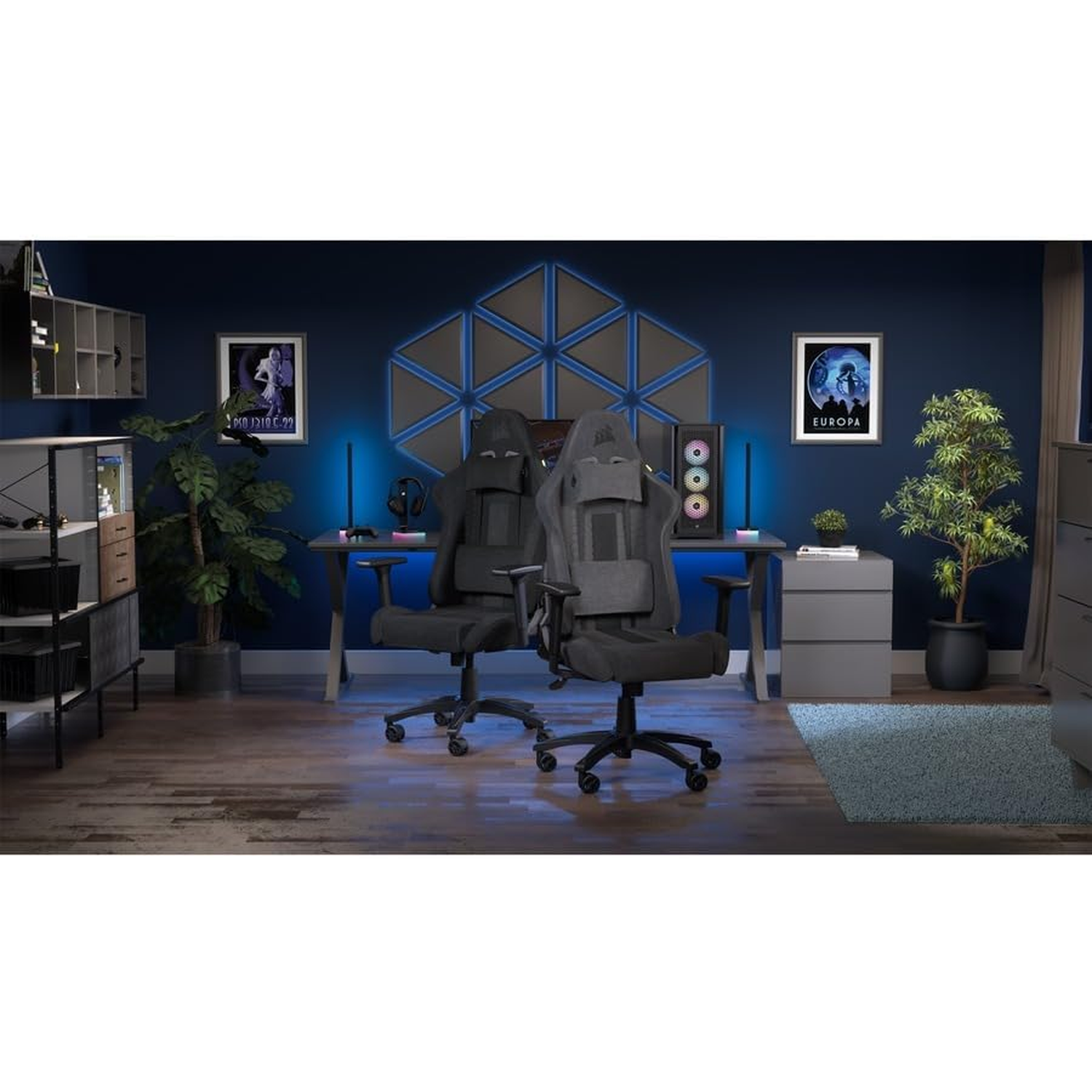 Two gaming chairs in a room with posters, a computer, and plants. The walls are dark blue.