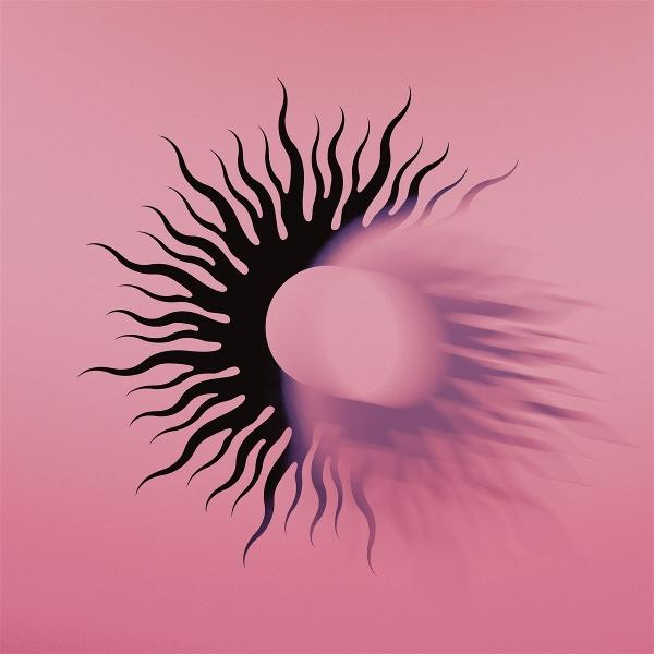 Ein schwarzes Sonnenstrahl-Design auf rosa Hintergrund. Ein weißer Zylinder in der Mitte mit Schatten.