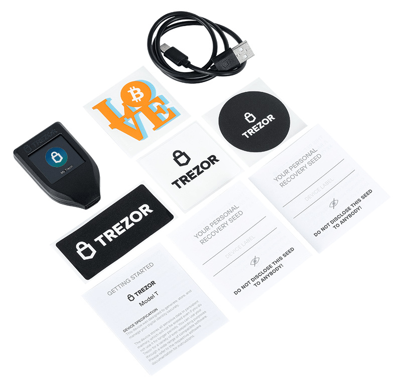 Urządzenie Trezor Model T, naklejki, kabel USB i karty instrukcji są wyświetlane na białej powierzchni. Urządzenie ma ekran.