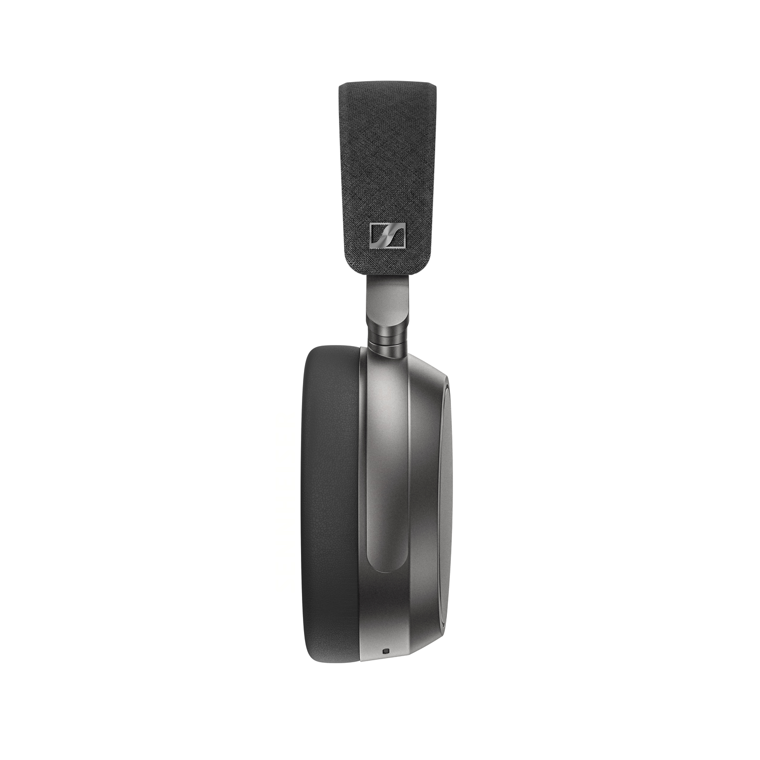 A side view of a modern, gray and black over-ear headphone. The band is fabric. The ear cup is a dark gray.