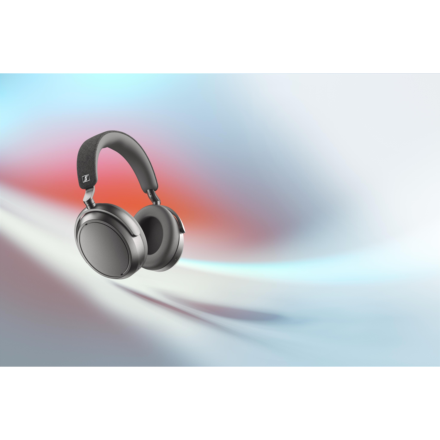 Floating black headphones. The background has a blurred gradient of red, blue, and white.