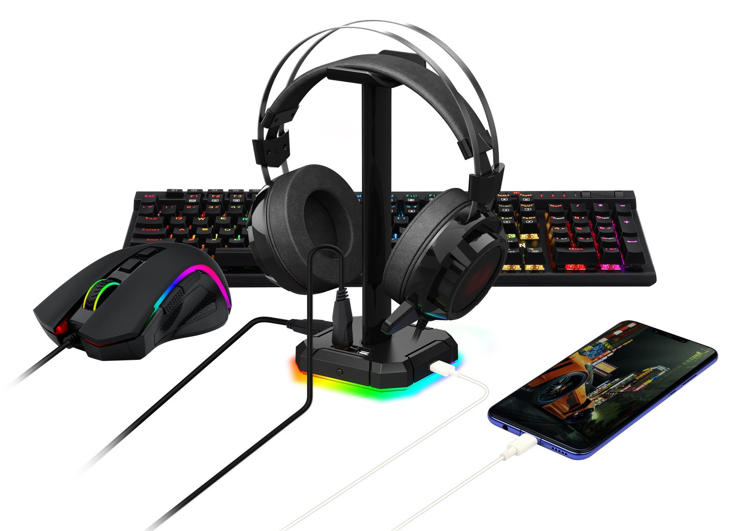 Konfiguracja do gier: słuchawki, klawiatury, mysz, telefon i stojak na zestaw słuchawkowy. Wszystko w czerni z podświetleniem RGB, na białym tle.