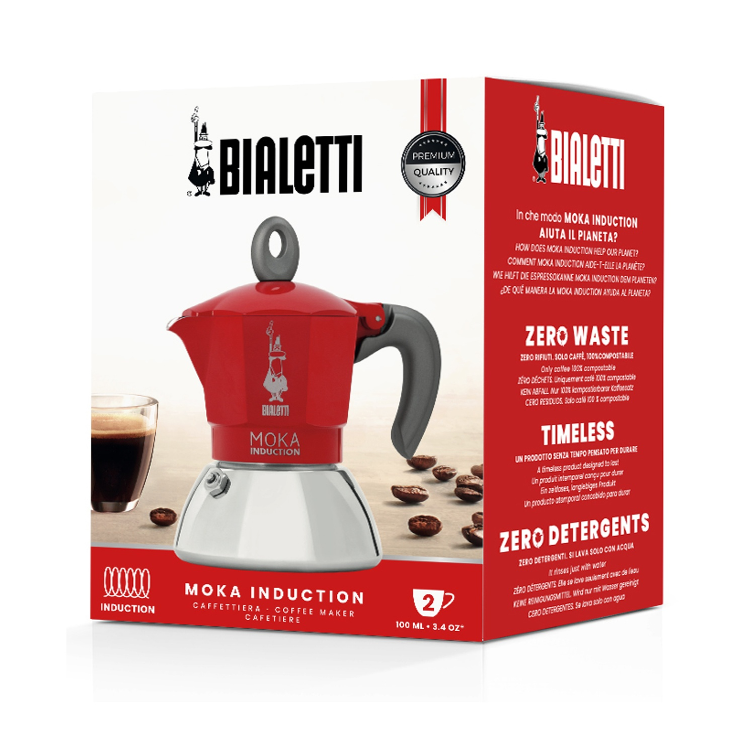 Caffettiera Bialetti Moka Induction rossa su una scatola. Chicchi di caffè e una tazza di caffè a sinistra.