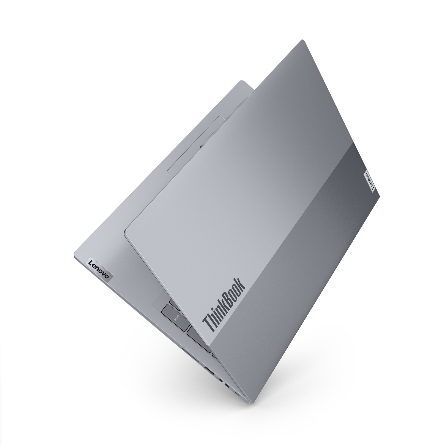Een zilveren Lenovo ThinkBook-laptop staat open op een zwarte achtergrond. Het Lenovo-logo is zichtbaar. Het toetsenbord is gedeeltelijk zichtbaar.