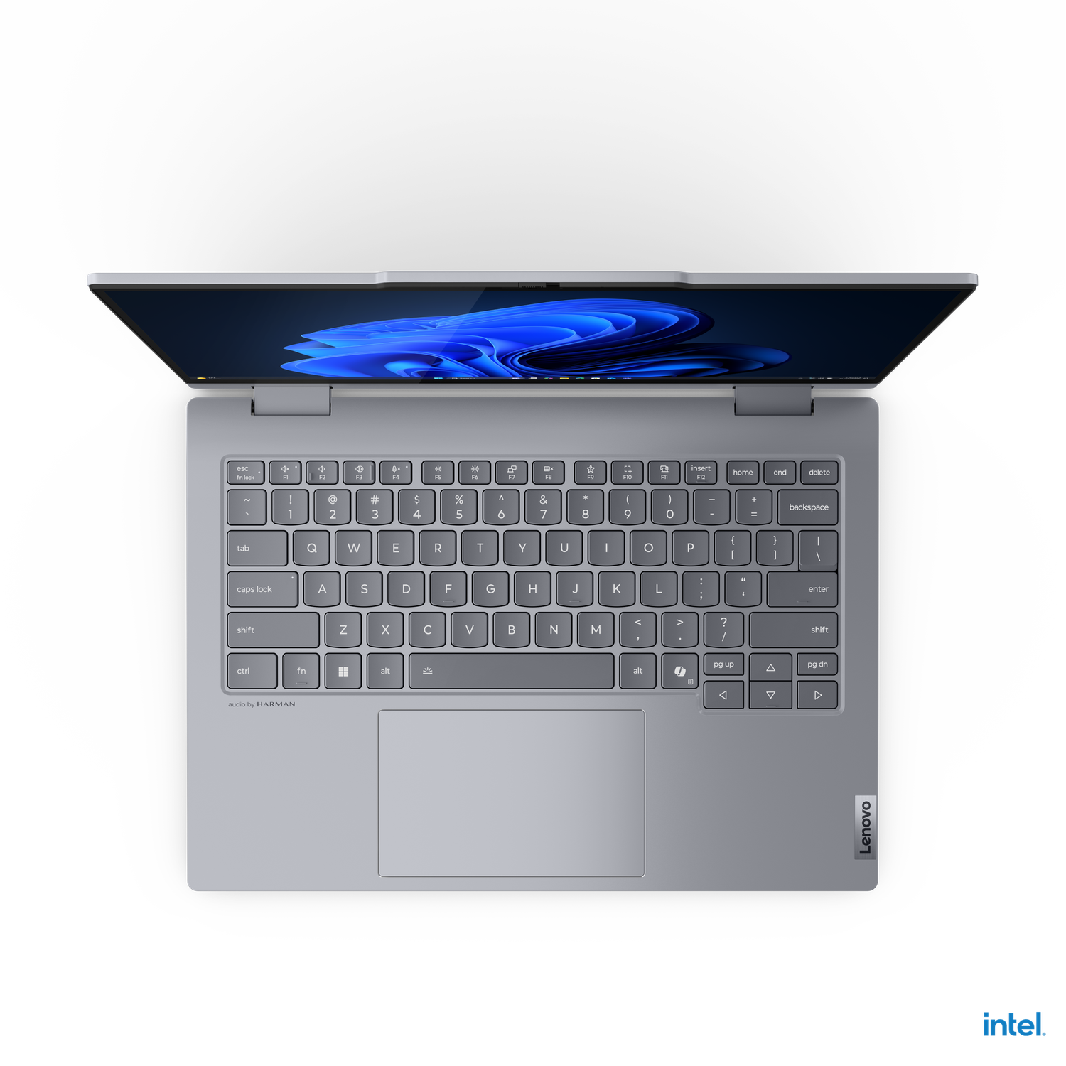 A gray Lenovo laptop is open, showing the keyboard and screen with a blue-swirl wallpaper against a black background.