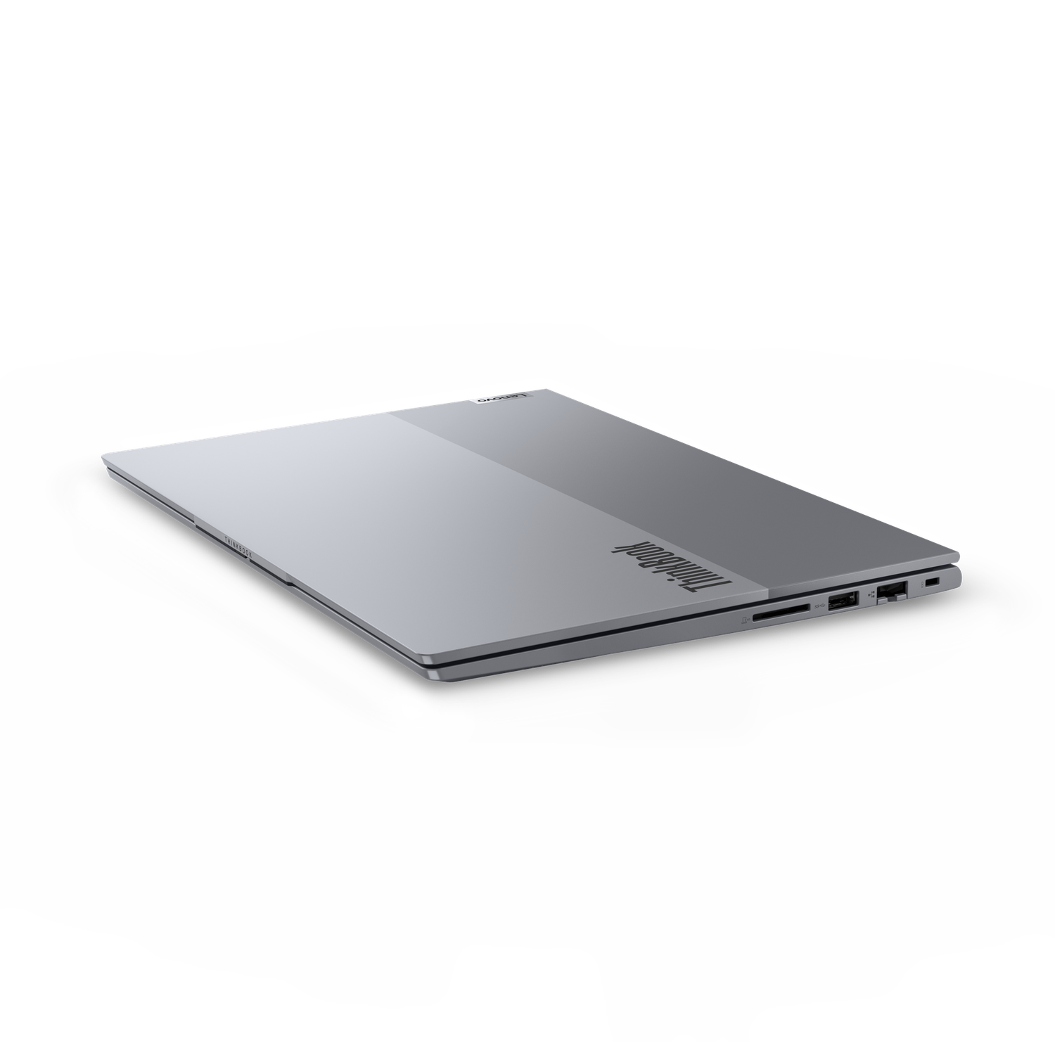 A closed, silver ThinkBook laptop on a black background. The ThinkBook logo is visible on the side.