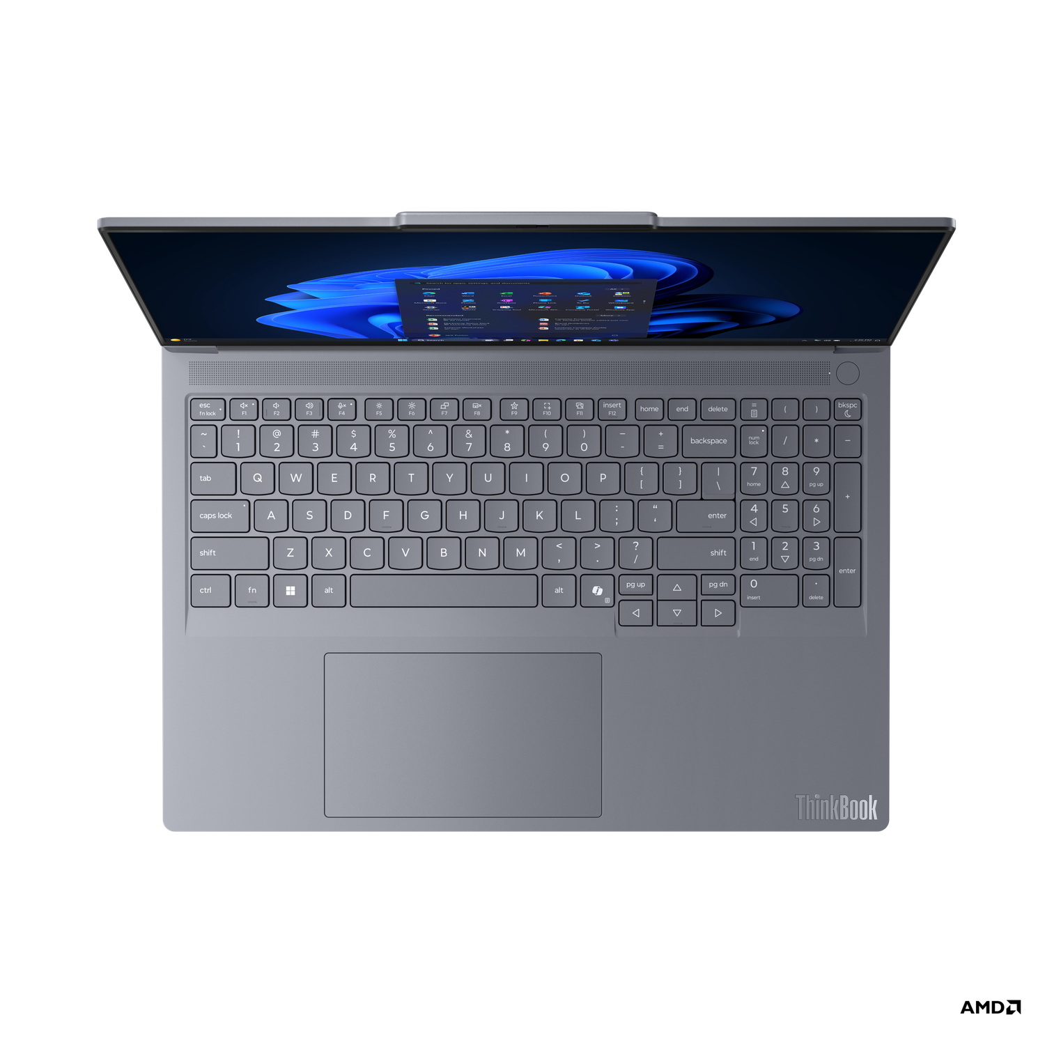 A gray ThinkBook laptop is open on a black surface. The screen shows a blue and white interface. The keyboard is visible.