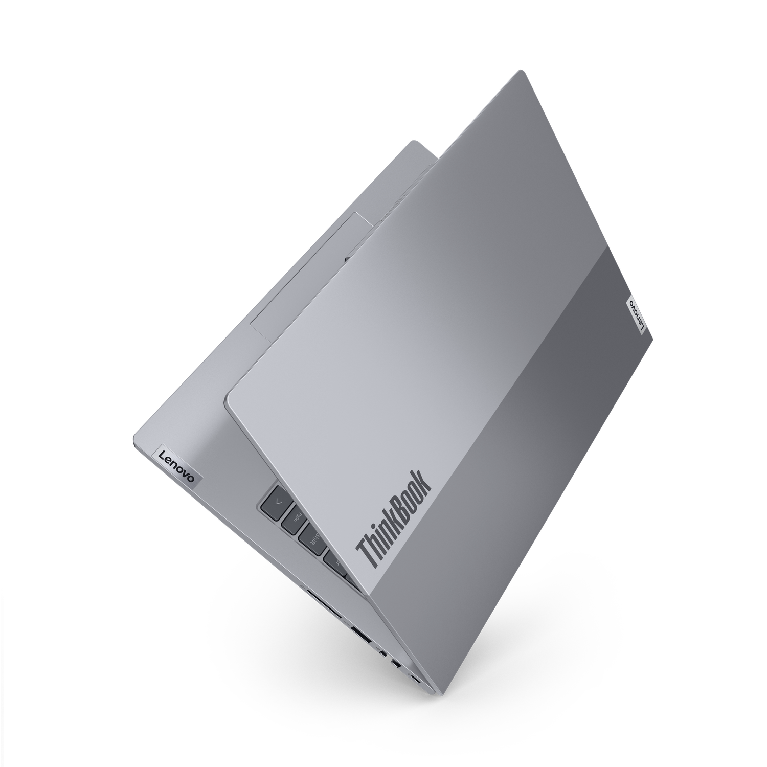 A silver Lenovo ThinkBook laptop is partially open, showing keyboard and screen. The background is black.