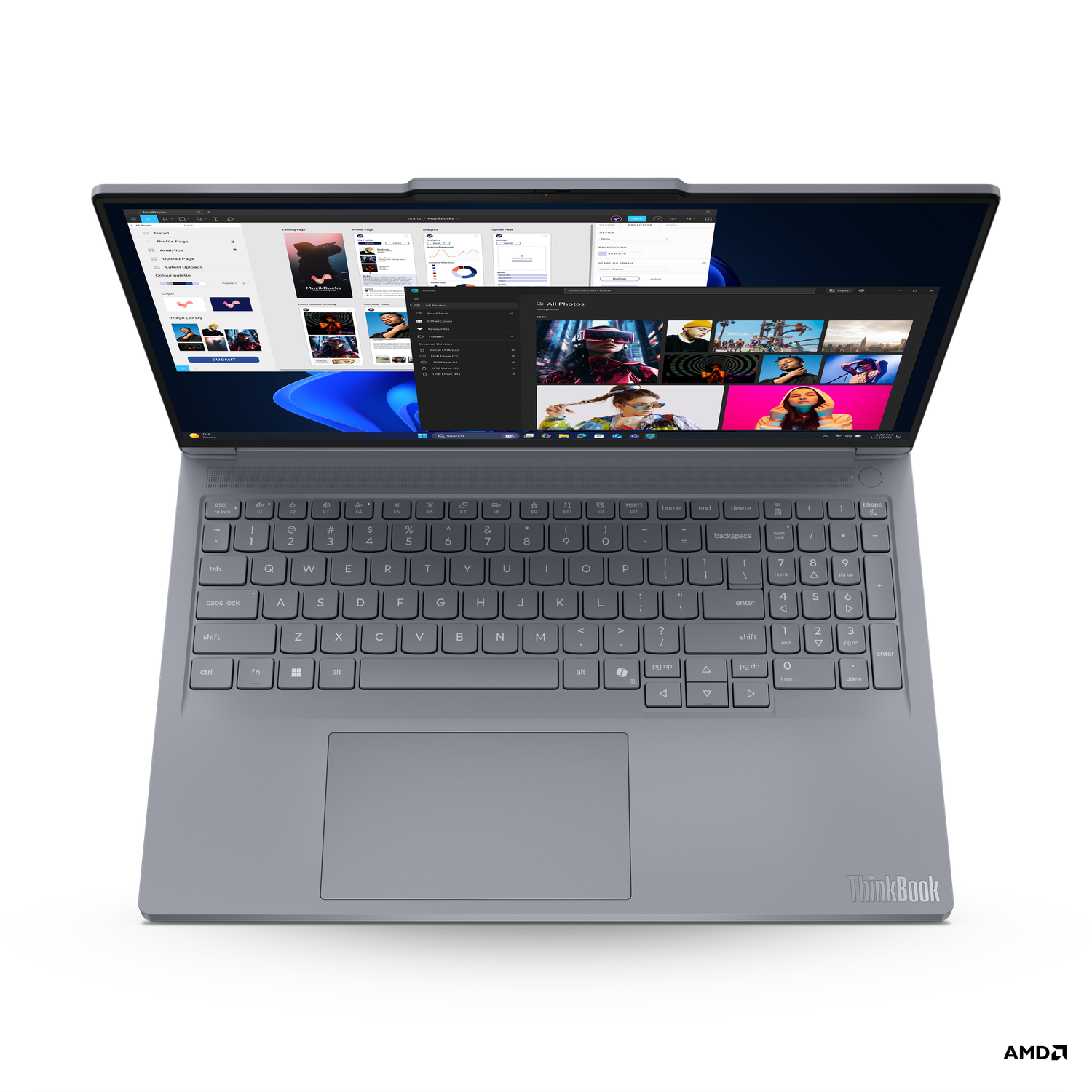An open grey ThinkBook laptop displaying multiple application windows, showcasing a keyboard and trackpad on a black background.