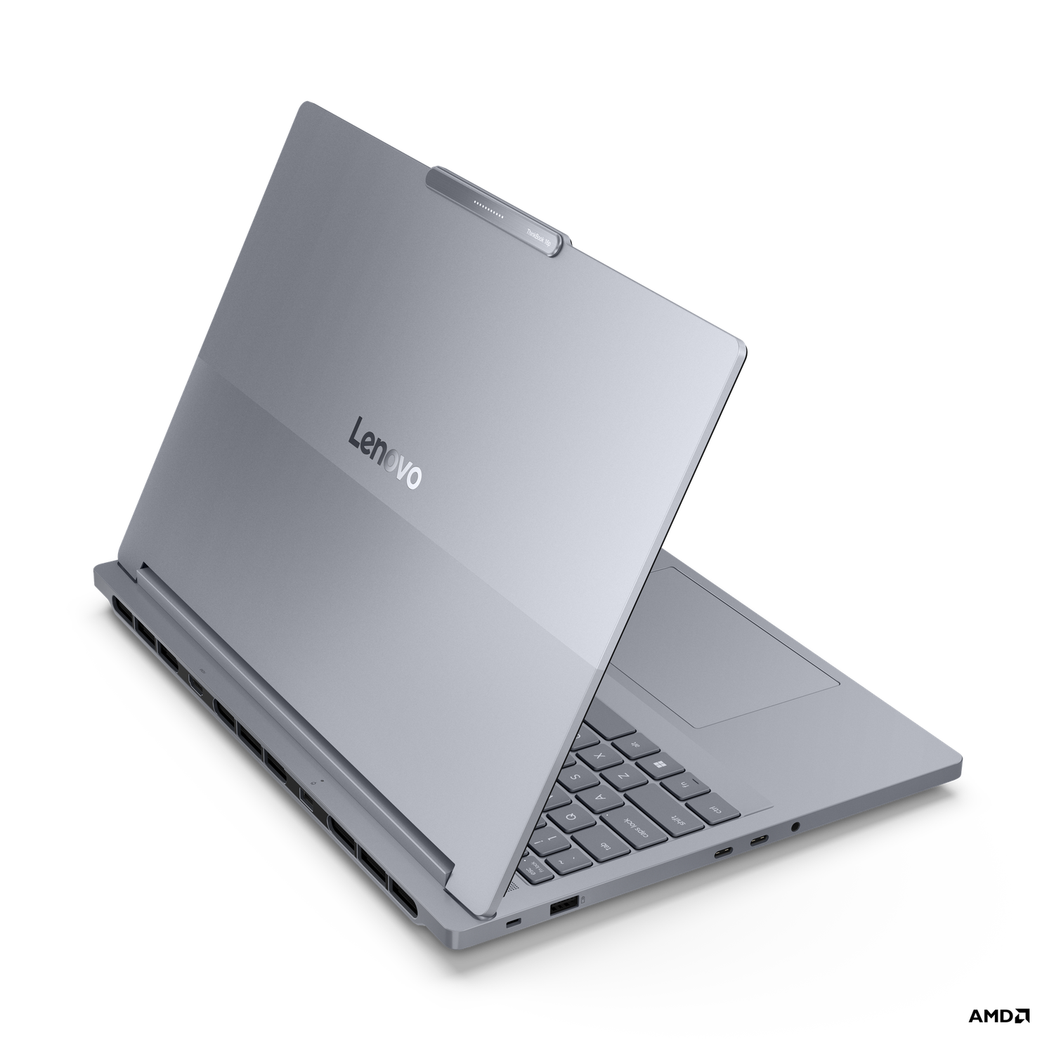 A silver Lenovo laptop is open, showing keyboard and screen. The Lenovo logo is visible on the lid, set against a black background.