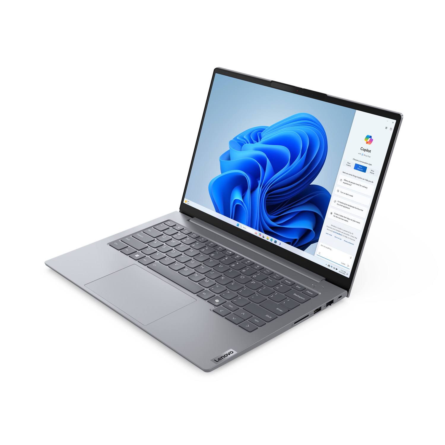 Een zilveren Lenovo laptop is open. Het scherm toont een blauwe abstracte achtergrond en een Copilot venster.