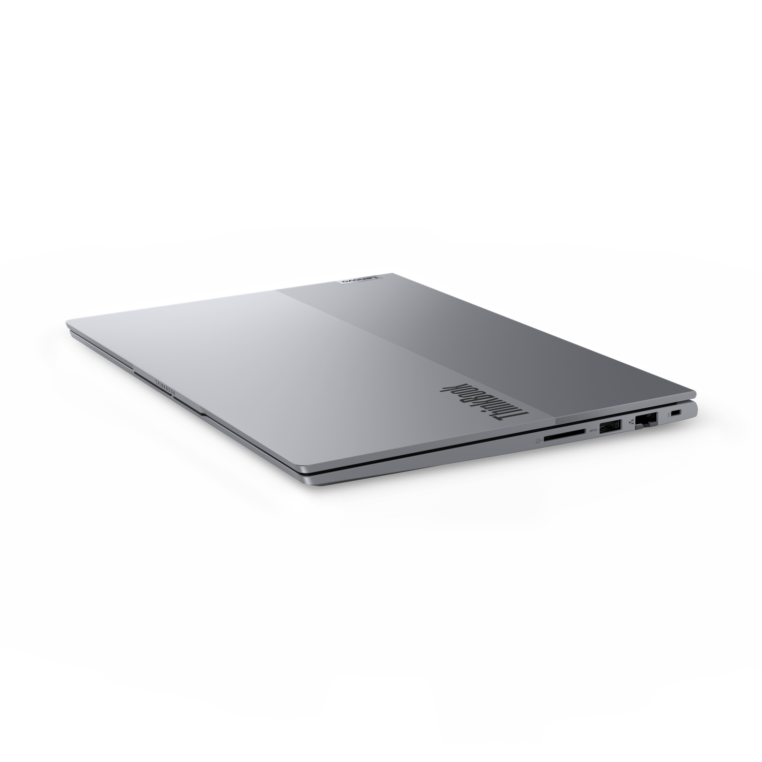 A silver ThinkBook laptop is slightly open, showing the side ports. The background is black.