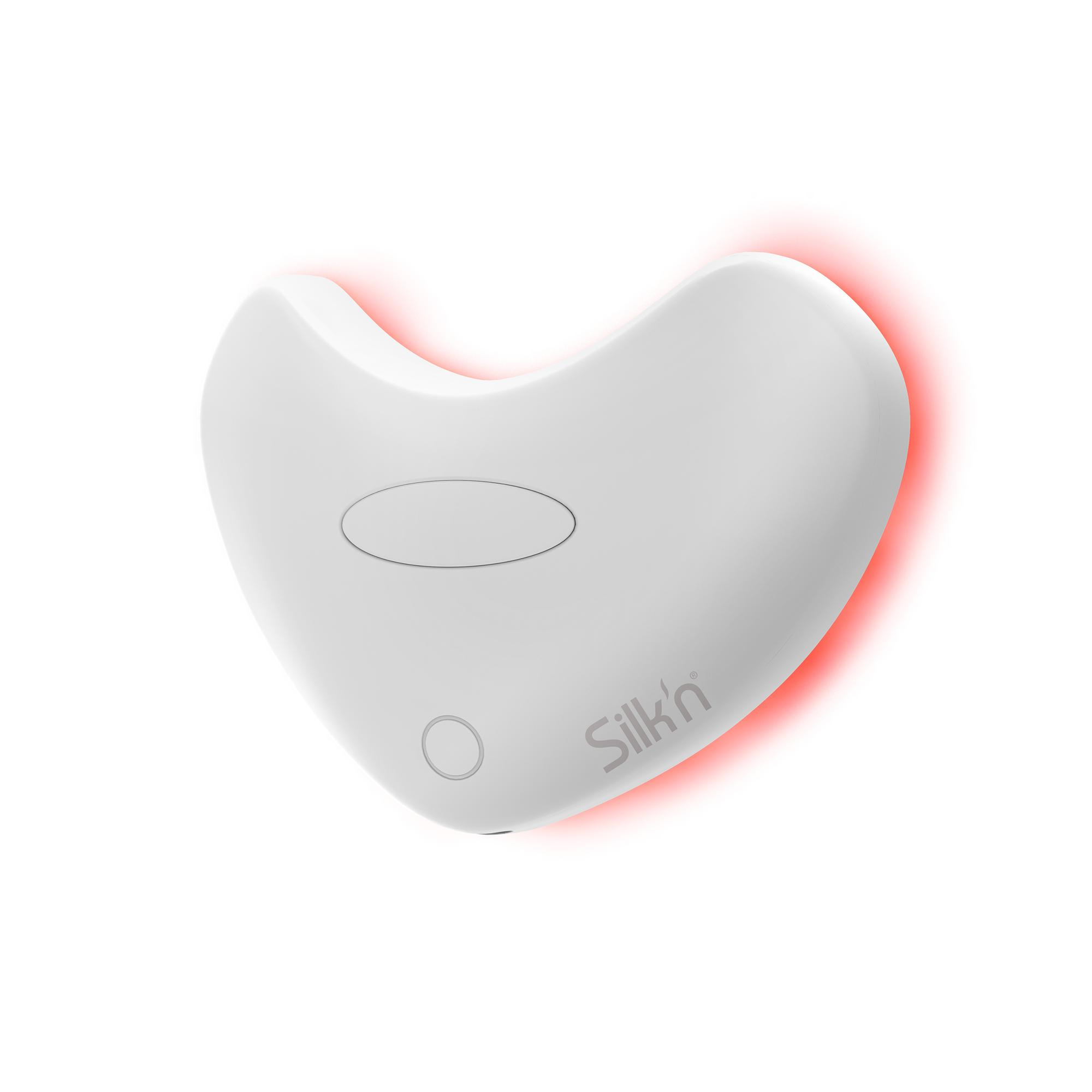 Białe urządzenie kosmetyczne w kształcie serca z czerwoną poświatą na krawędziach. Ma przyciski i markę Silk'n.