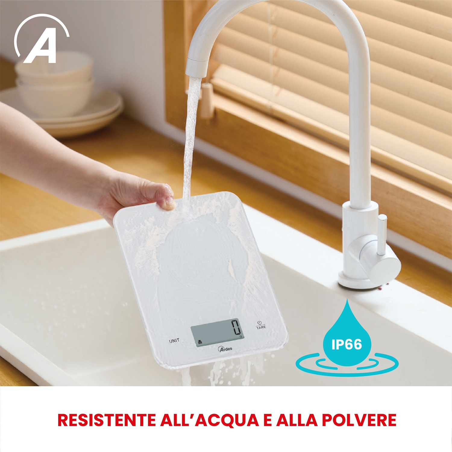 Una mano tiene una bilancia bianca sotto l'acqua corrente. La bilancia è in un lavandino. Il testo recita: "RESISTENTE ALL'ACQUA E ALLA POLVERE".