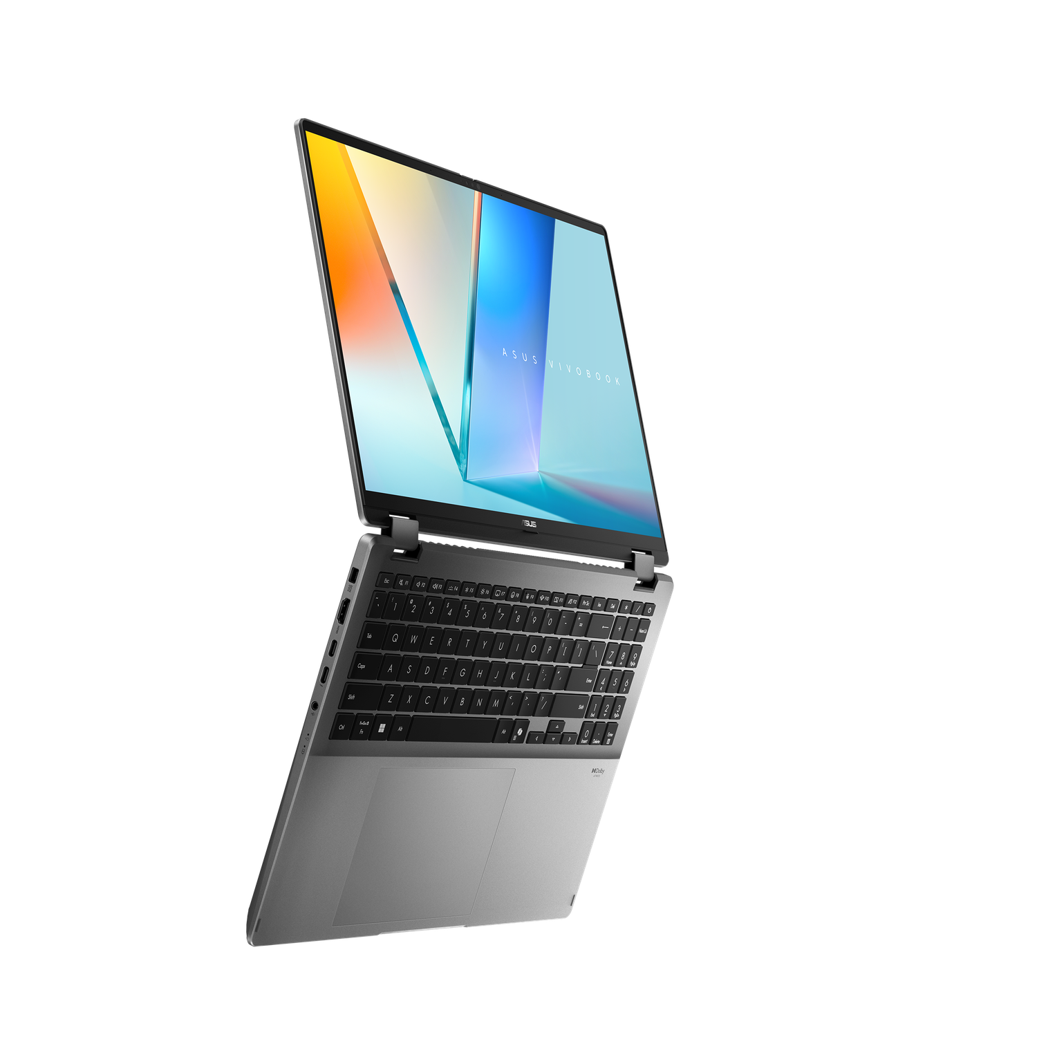 A silver Asus Vivobook laptop is open against a black background. The screen displays colorful abstract graphics. The keyboard is visible.