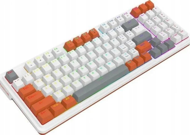 Biała i pomarańczowa klawiatura mechaniczna na białej powierzchni. Klawisze są białe, pomarańczowe i szare.