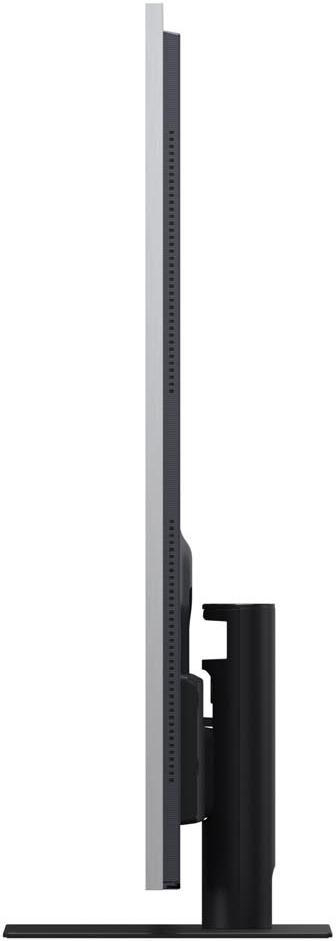 Seitenansicht eines großen, dünnen Monitors mit schwarzem Ständer. Der Bildschirm ist grau, mit schwarzem Rand.
