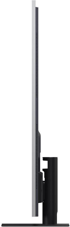 Seitenansicht eines hohen, dünnen Fernsehers. Der Bildschirm ist grau und hat eine schwarze Seite mit Lüftungsschlitzen. Er steht auf einem schwarzen Ständer.