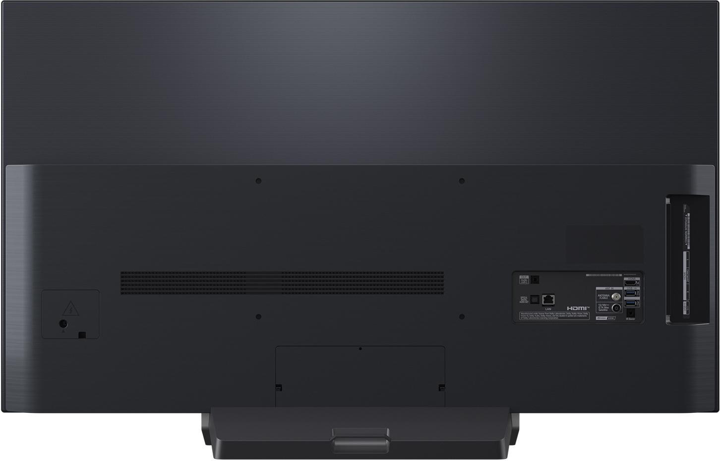 Die Rückseite eines großen schwarzen Fernsehers. Es hat verschiedene Anschlüsse für Strom, HDMI und andere Geräte. Ein Ständer ist angebracht.