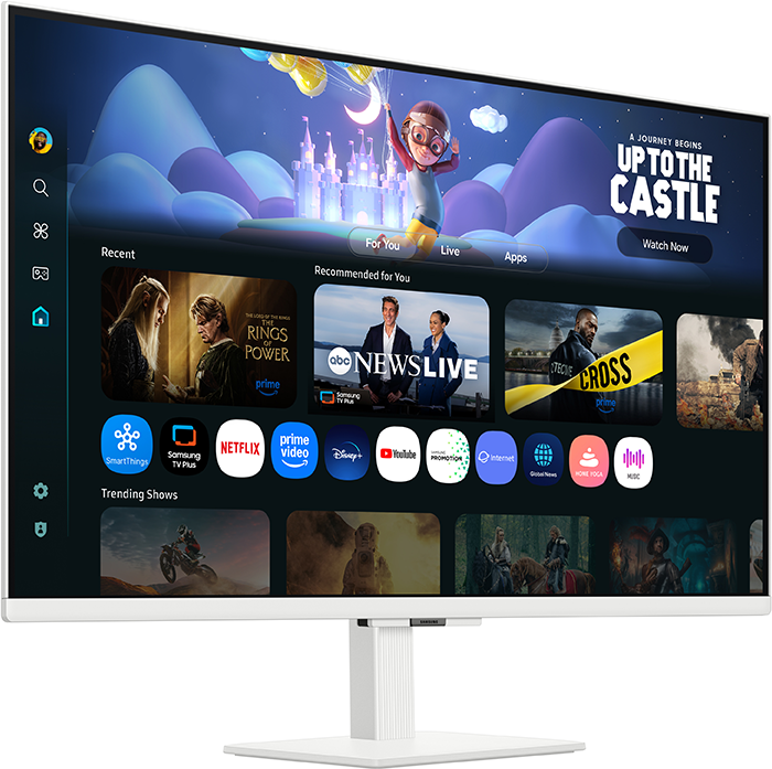 Egy fehér Samsung monitor egy streaming szolgáltatás felületét jeleníti meg. A képernyőn különböző alkalmazások és műsorok, valamint egy rajzolt kastély látható.
