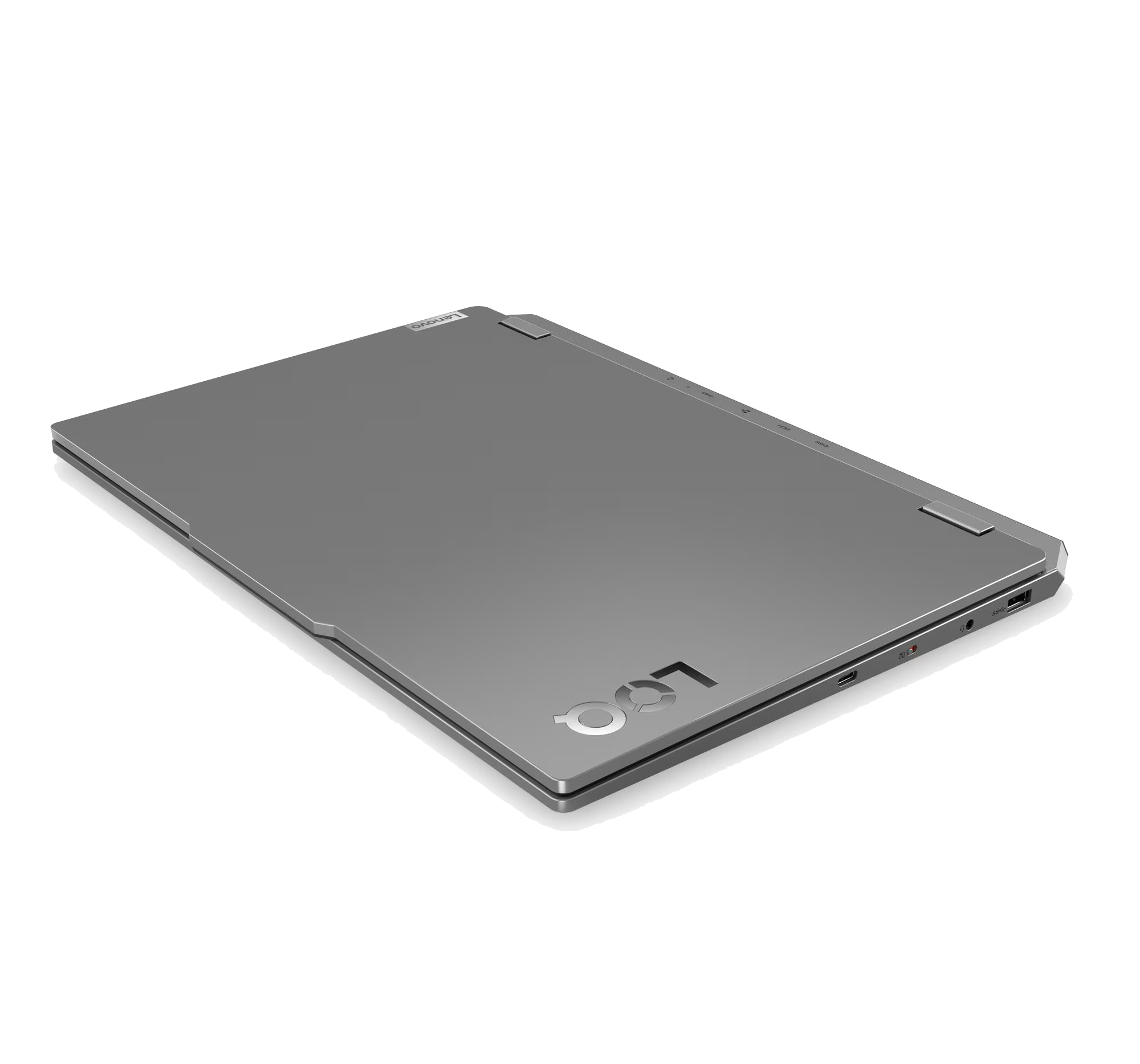 Un portátil plateado sobre fondo negro. El logotipo de Lenovo es visible. El portátil está cerrado.