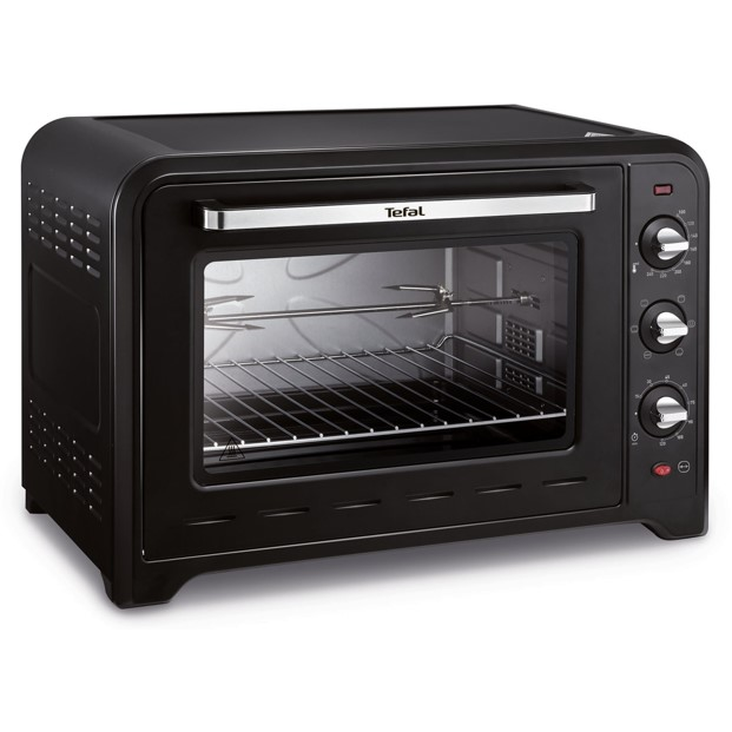 A black Tefal oven with a glass door, dials, and a handle. Inside, there's a grill and rotisserie. The oven is on a white surface.