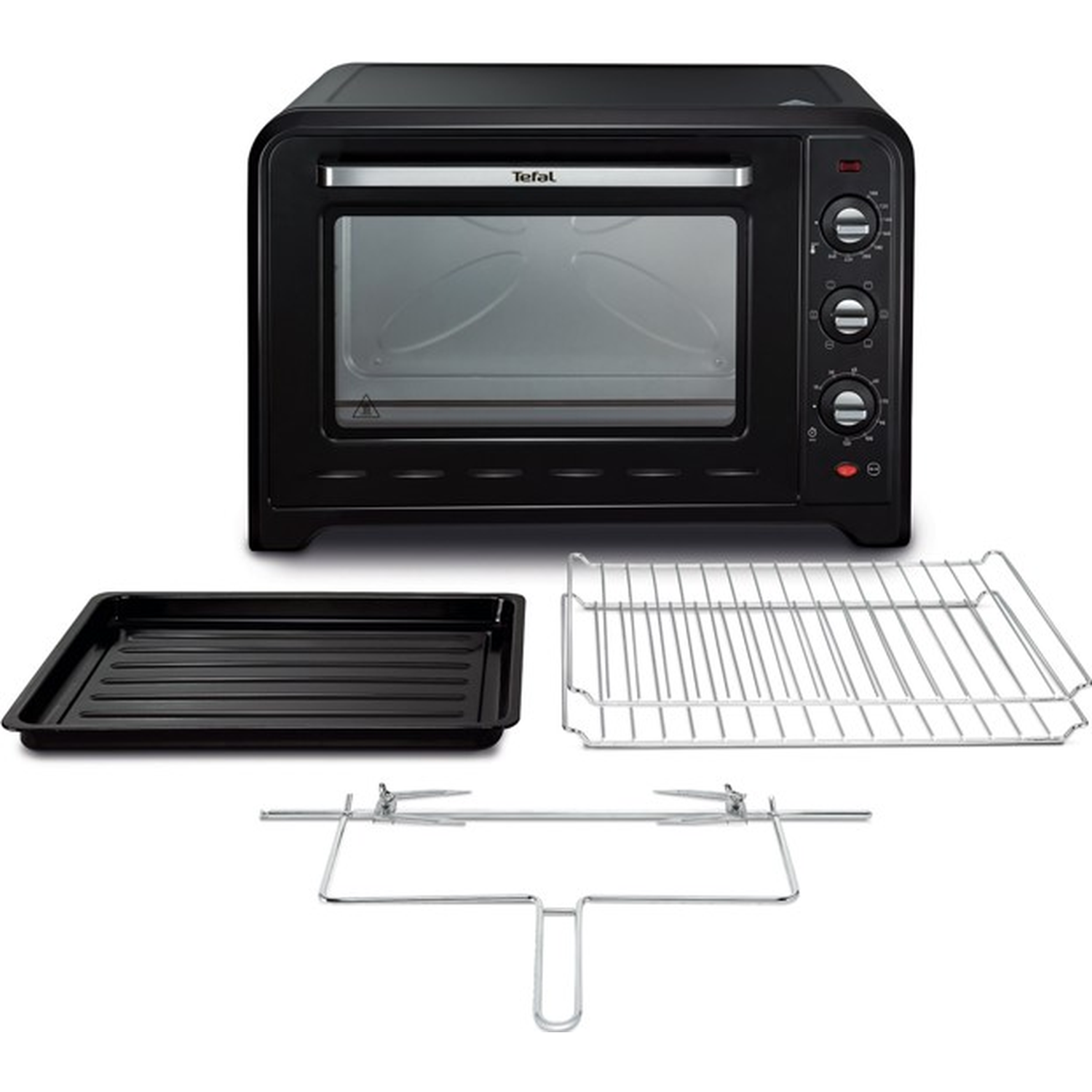Black Tefal oven with accessories: tray, rack, and rotisserie fork. Controls on the right. Glass door shows interior.