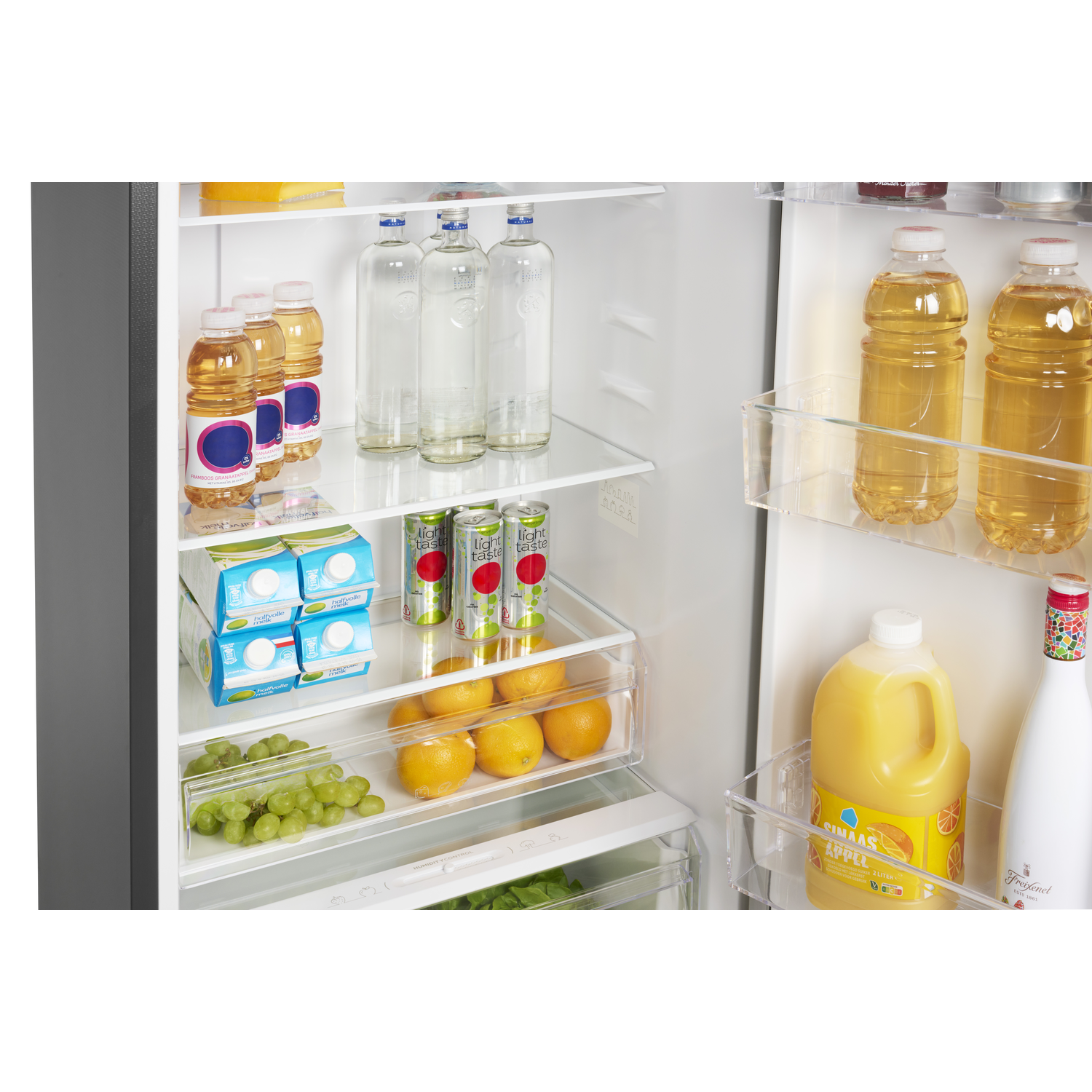 Inside a refrigerator: bottles of water, juice, and milk cartons. Also, fruits like grapes and oranges are visible.