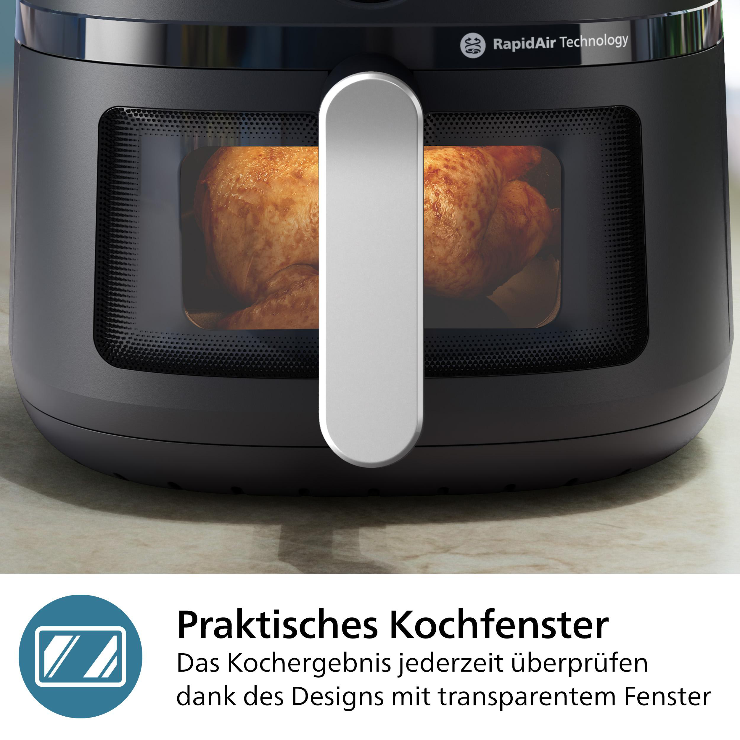 Schwarze Heißluftfritteuse mit Fenster, das ein Brathähnchen zeigt. Mit silbernem Griff und Rapid Air Technology.