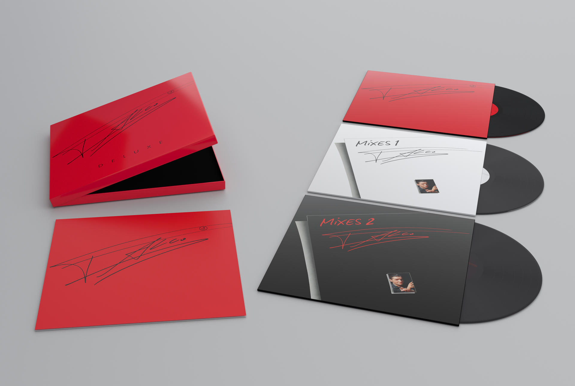 Rotes Deluxe-Box-Set mit Unterschrift. Vinyl-Schallplatten in Hüllen, Mixes 1 und 2, mit Künstlerbild. Alles auf grauer Oberfläche.